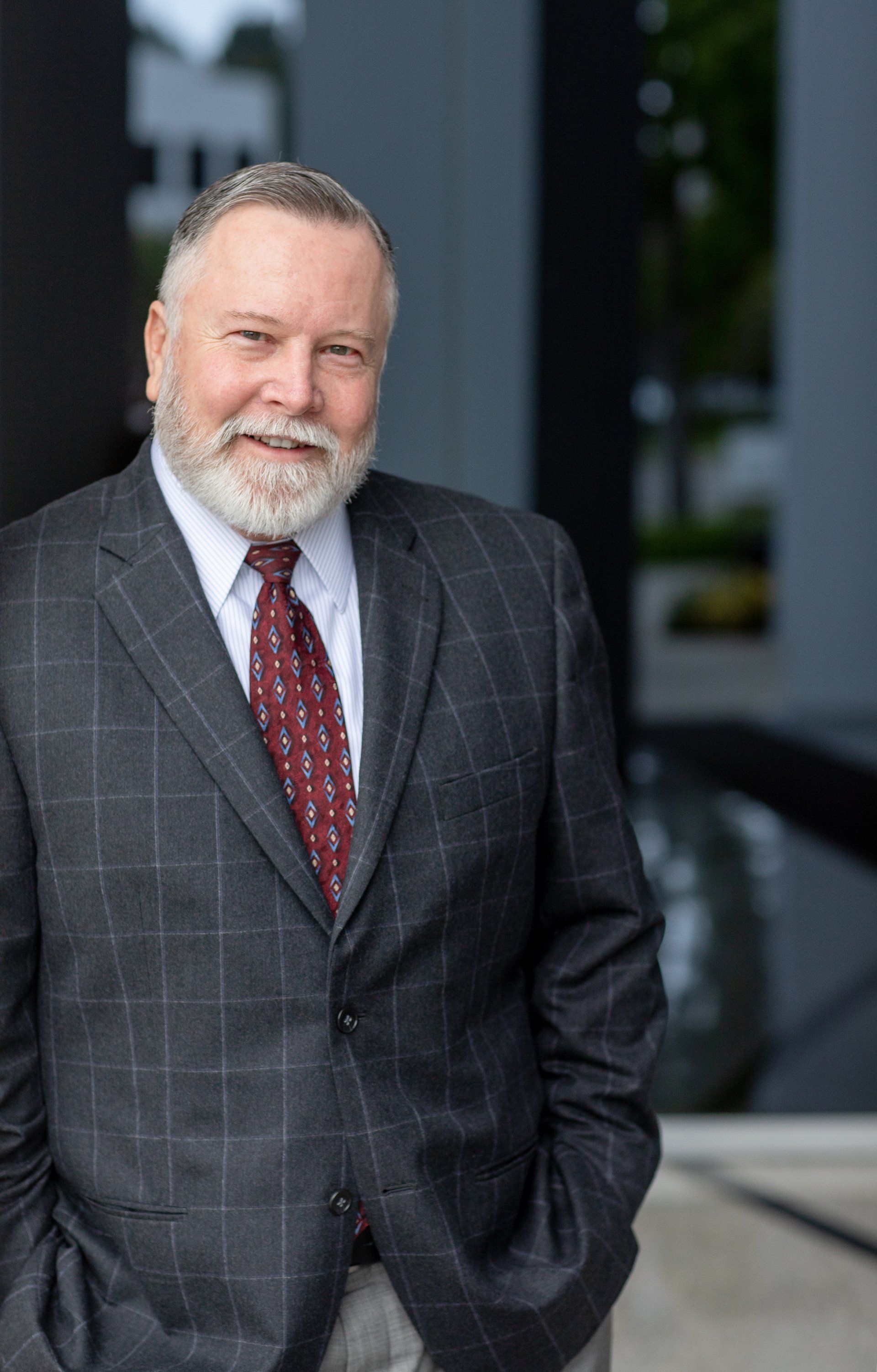 Senior financial advisor headshot in a plaid suit