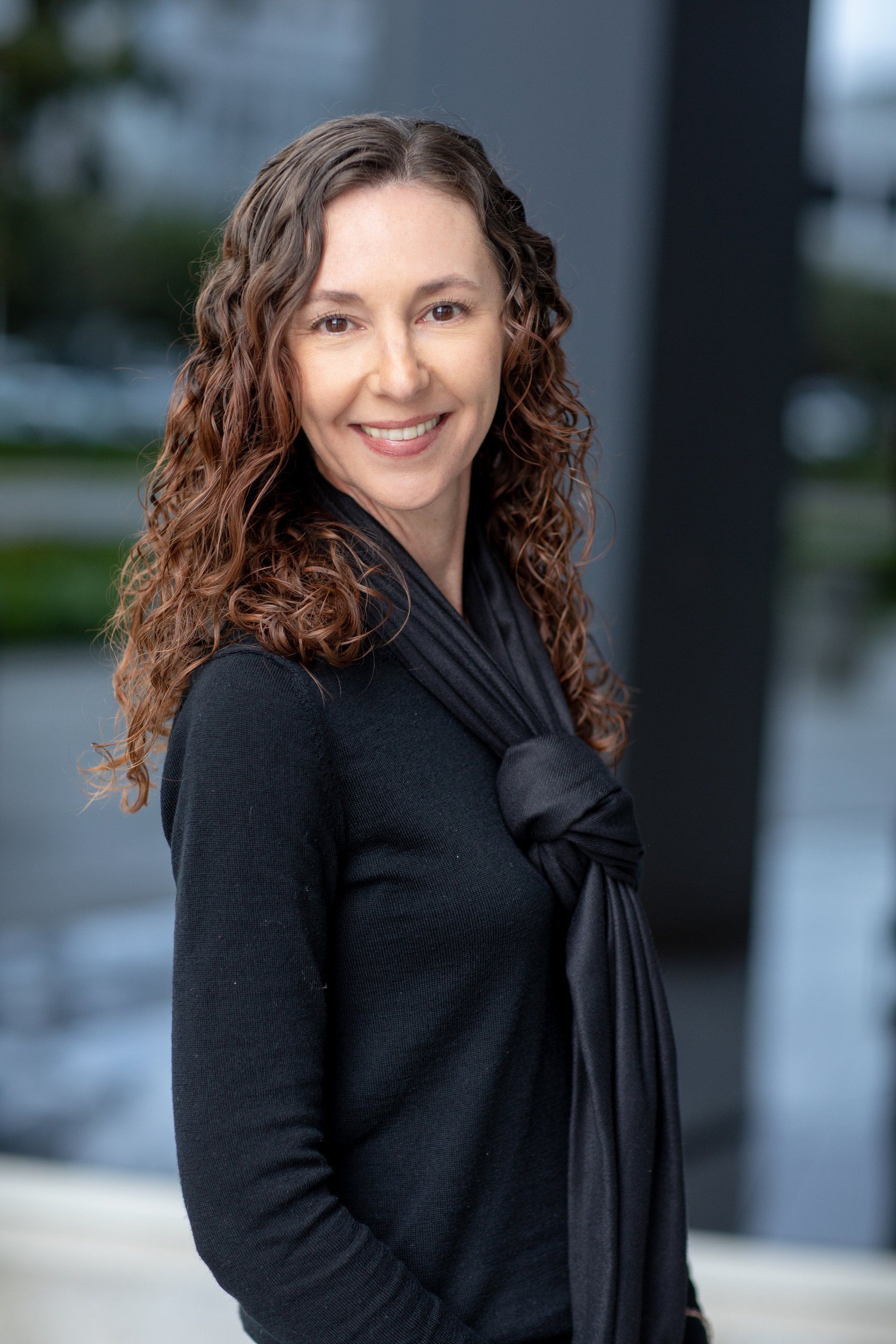 Insurance professional headshot of a woman with curly hair