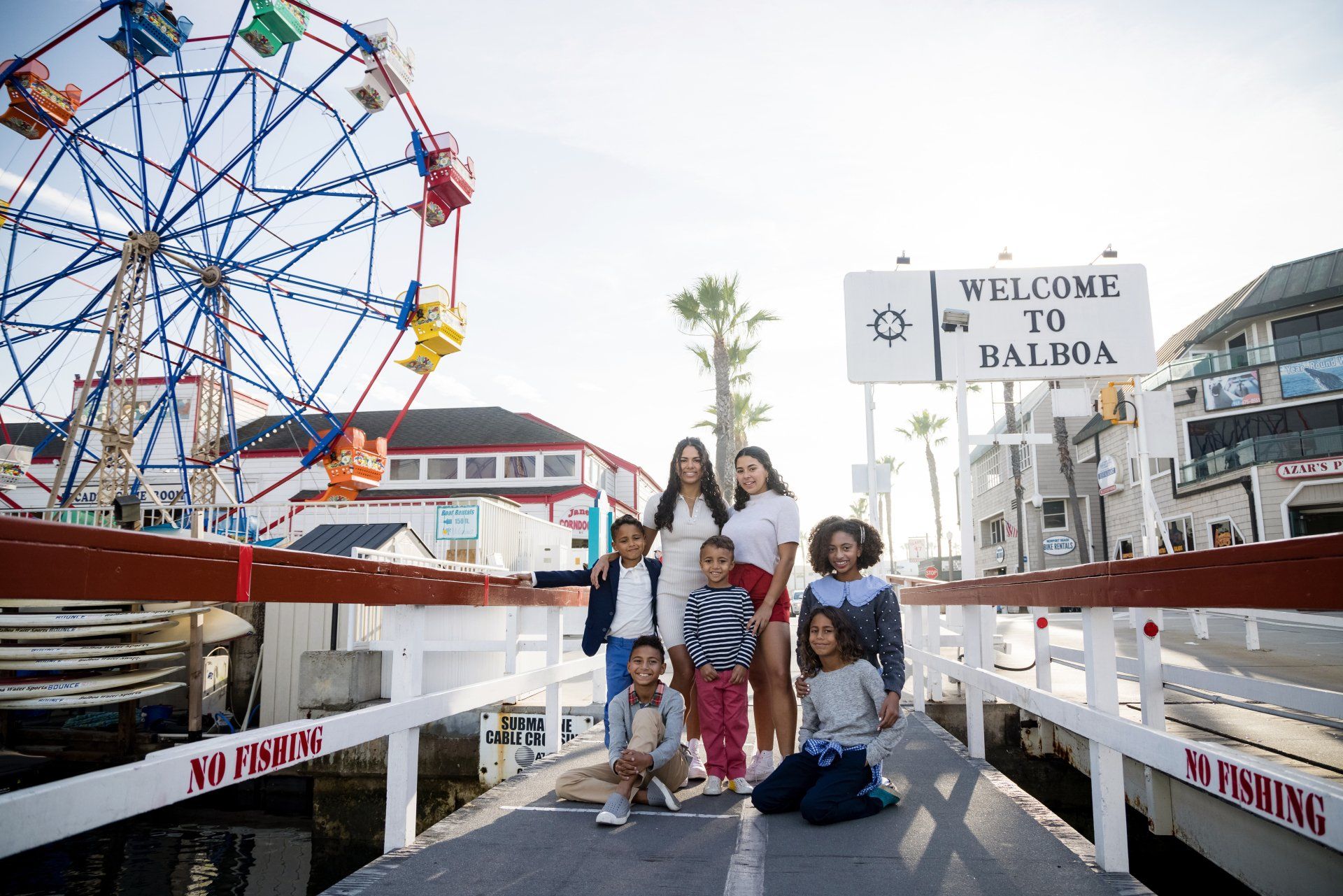 Family portrait at the Balboa Fun Zone in Newport Beach by a Laguna Beach family photographer