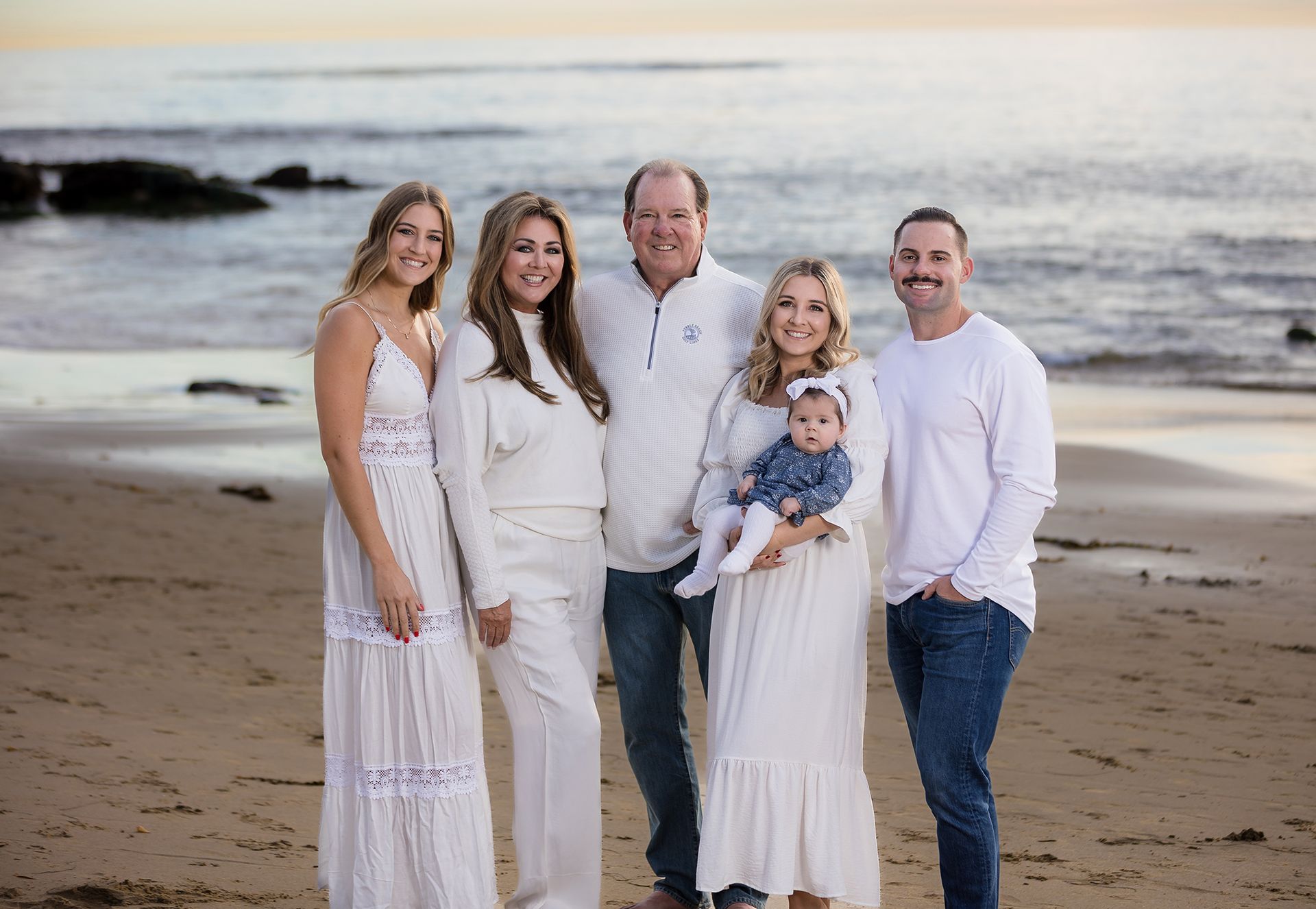 Extended family standing together on the sand at Picnic Beach, Laguna Beach