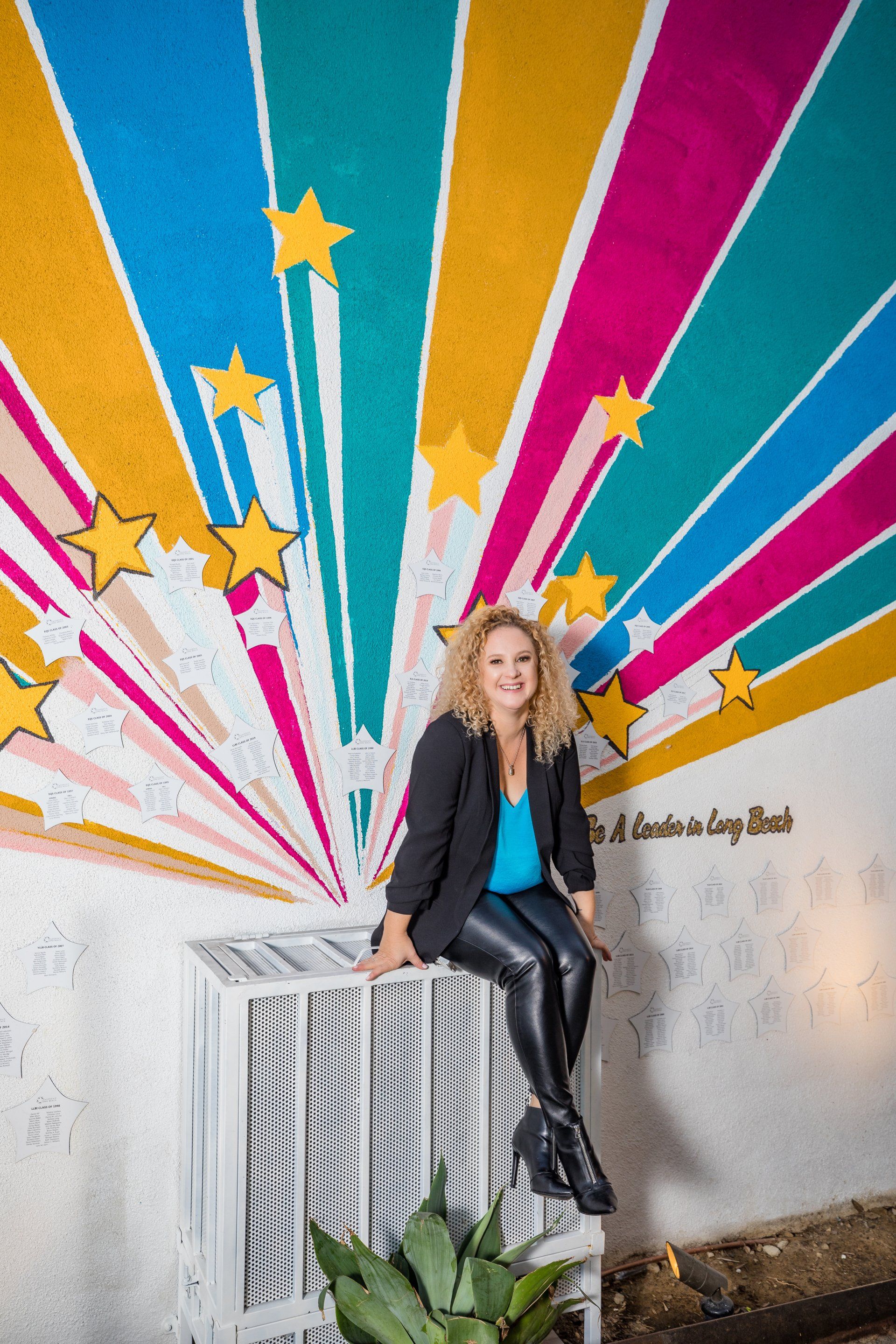 Creative headshot in front of a rainbow mural in Orange County