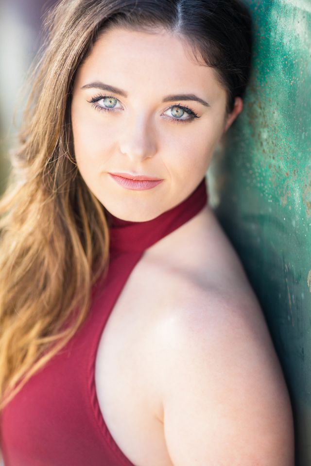 Senior girl in burgundy against a green wall, Orange County