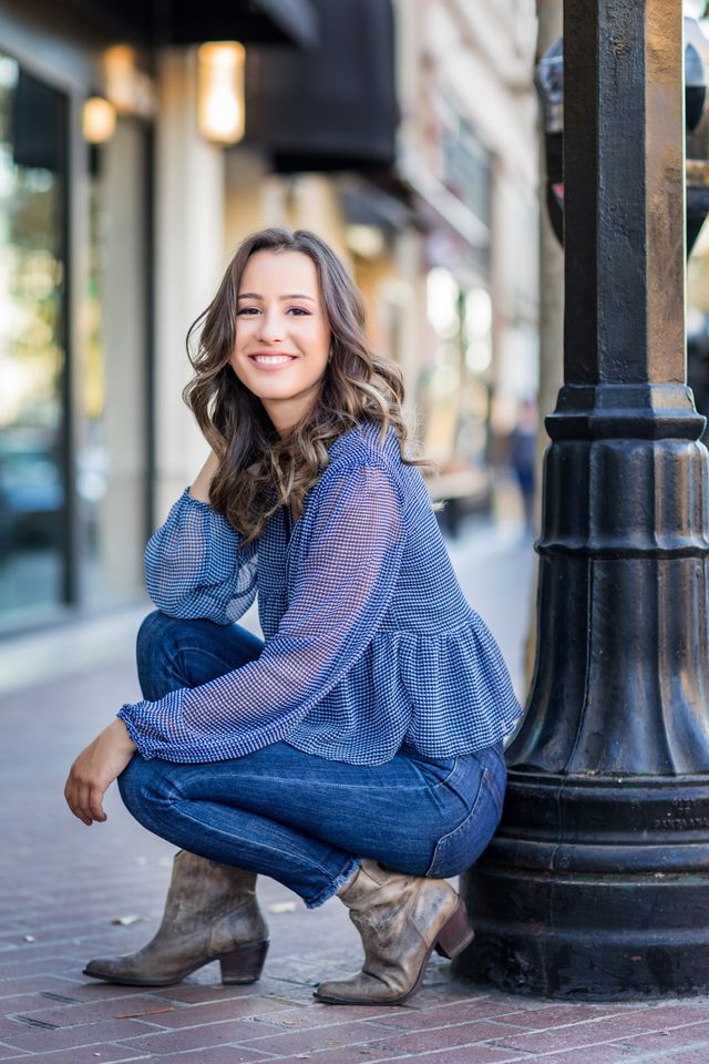 Senior girl crouching by a lamp post, Orange County