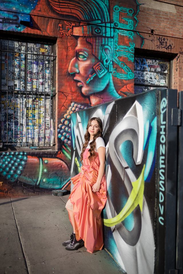 Senior girl in a flowing dress by a mural, Orange County