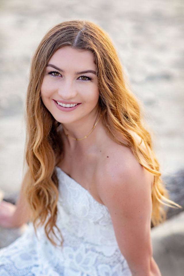 Smiling senior girl with long hair by the ocean, Laguna Beach