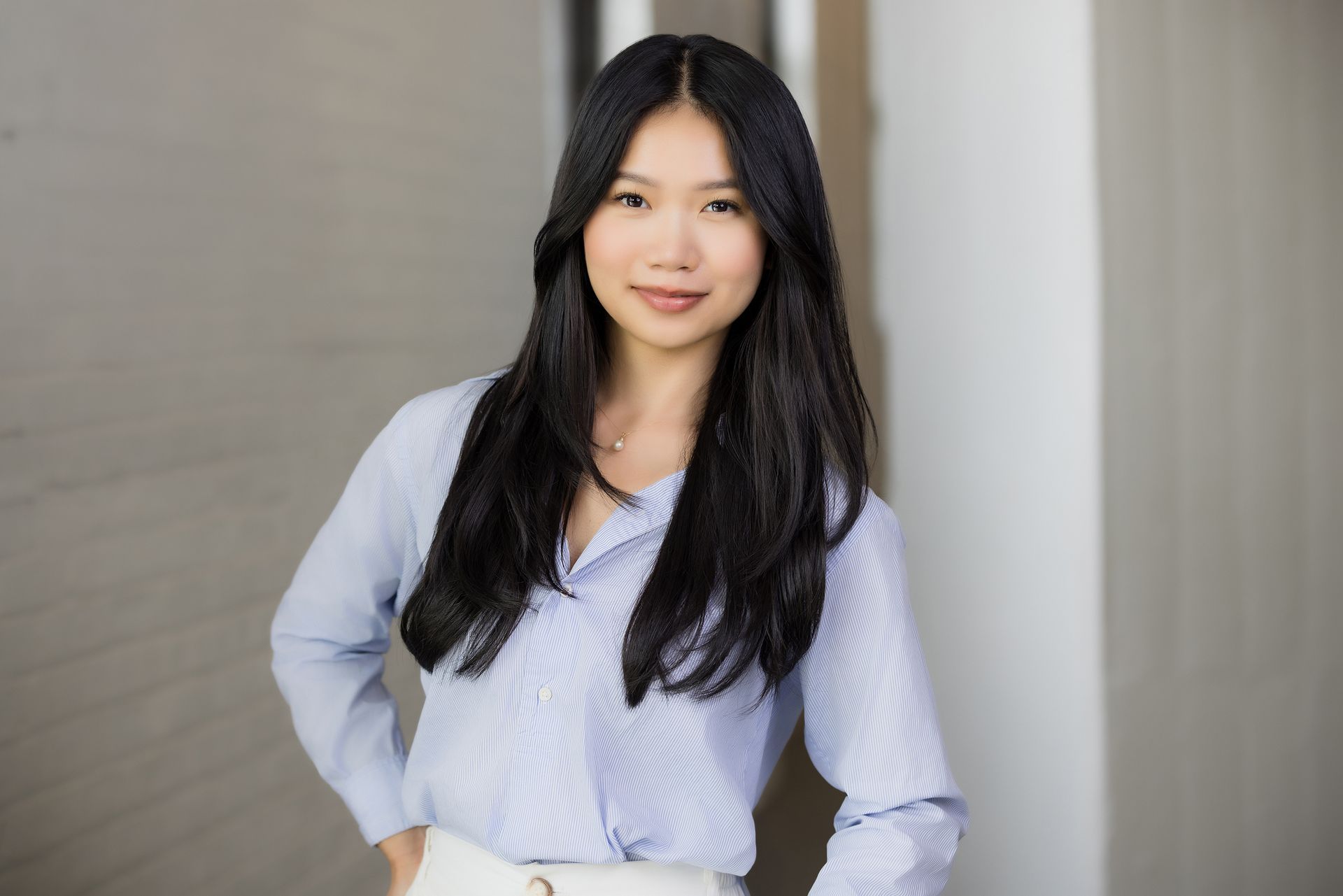 Trade show headshot of a woman in a light blue shirt