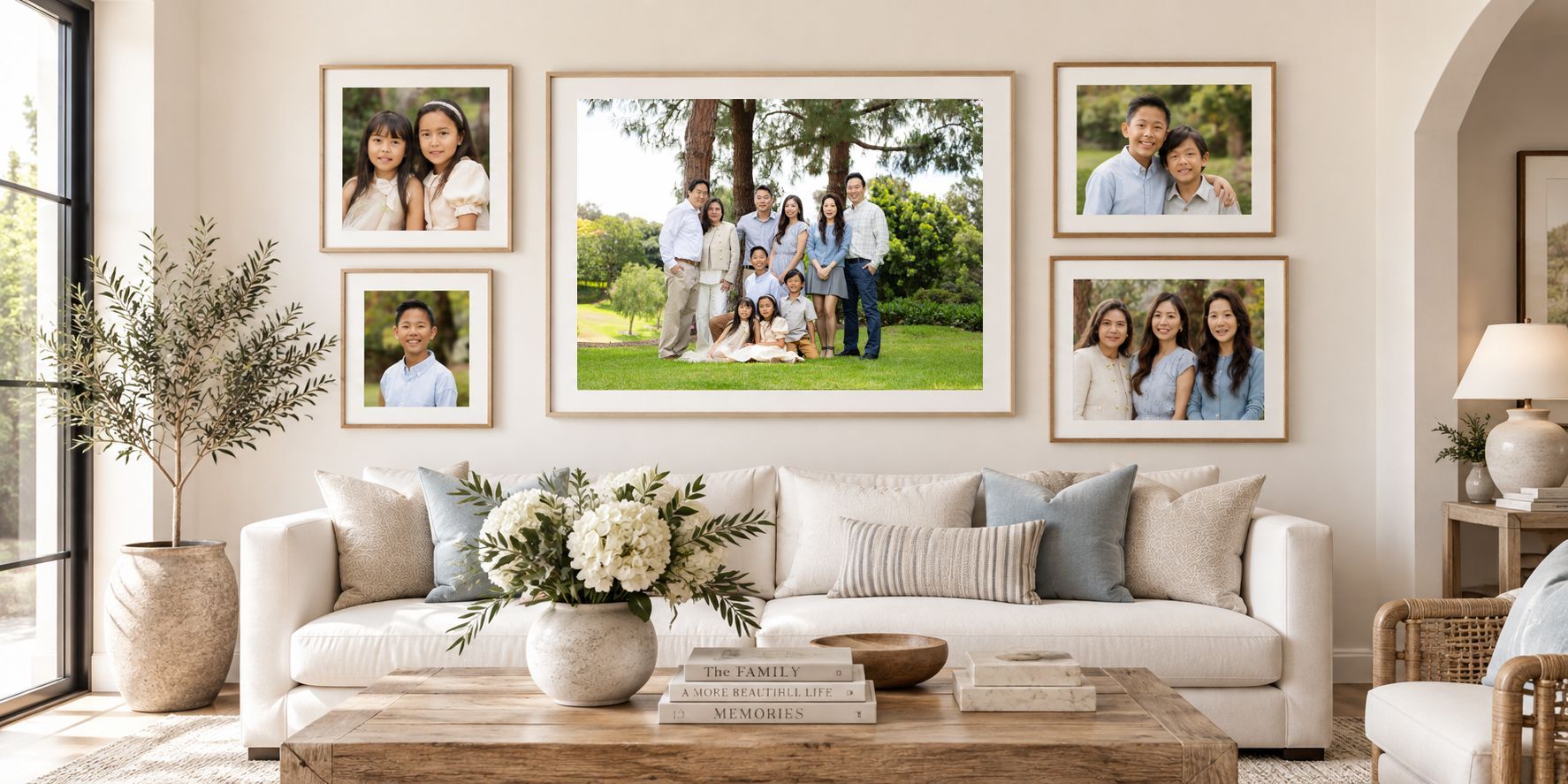 Framed extended family portraits hanging on a living room wall, photographed by Blue Sky's Studio
