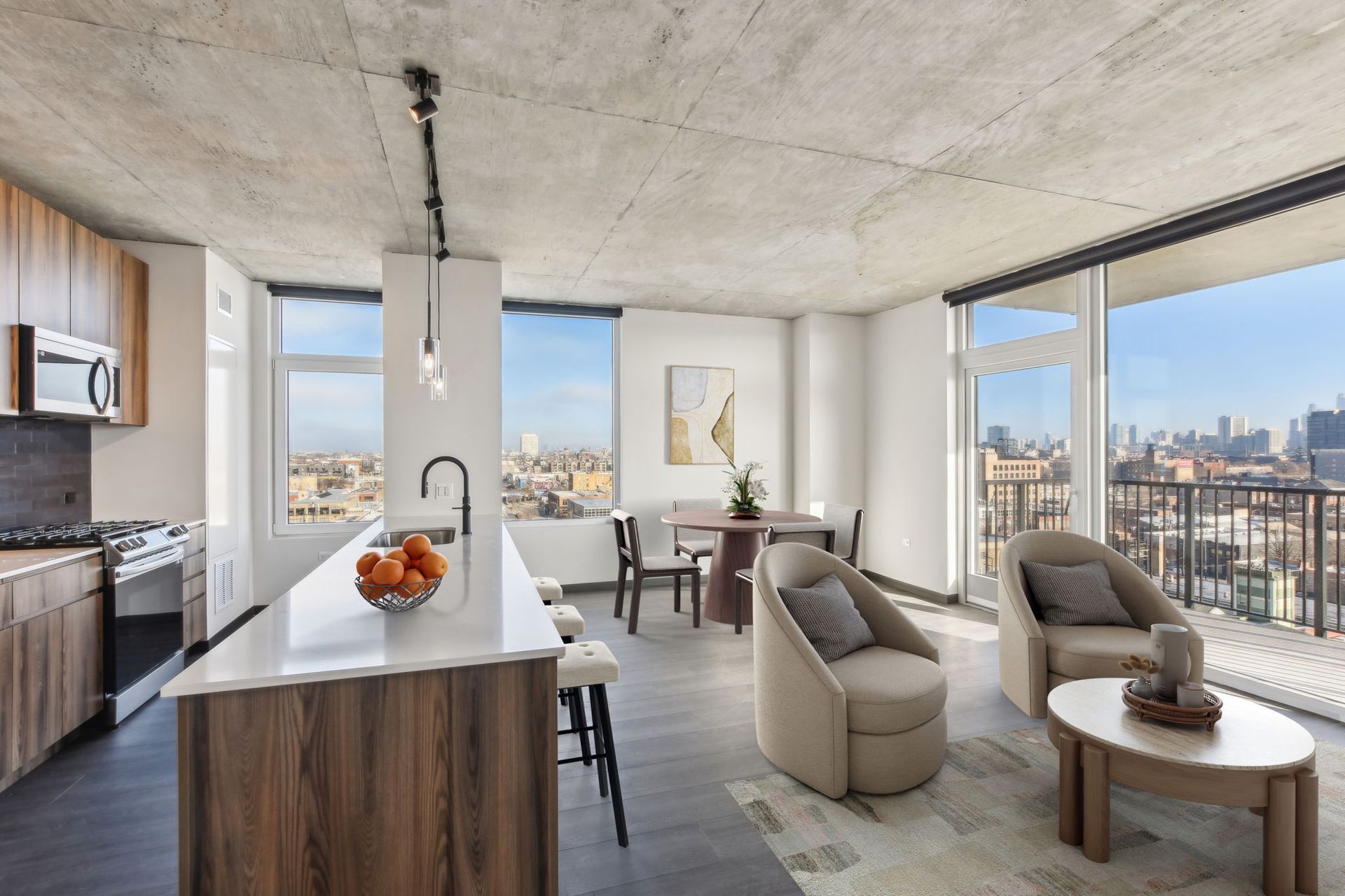 A living room with a view of the city and a kitchen