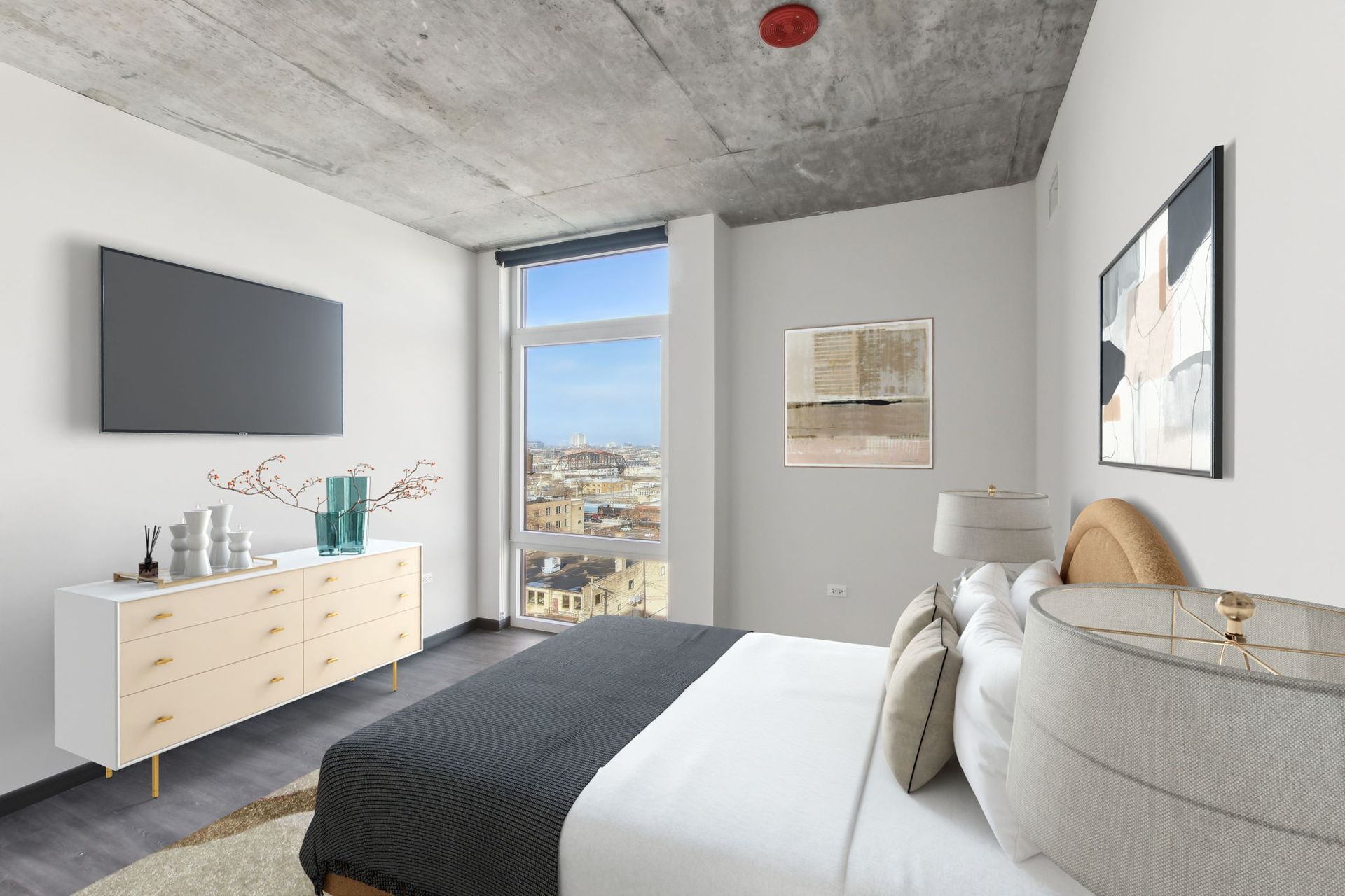 A bedroom with a bed , dresser , television and window.