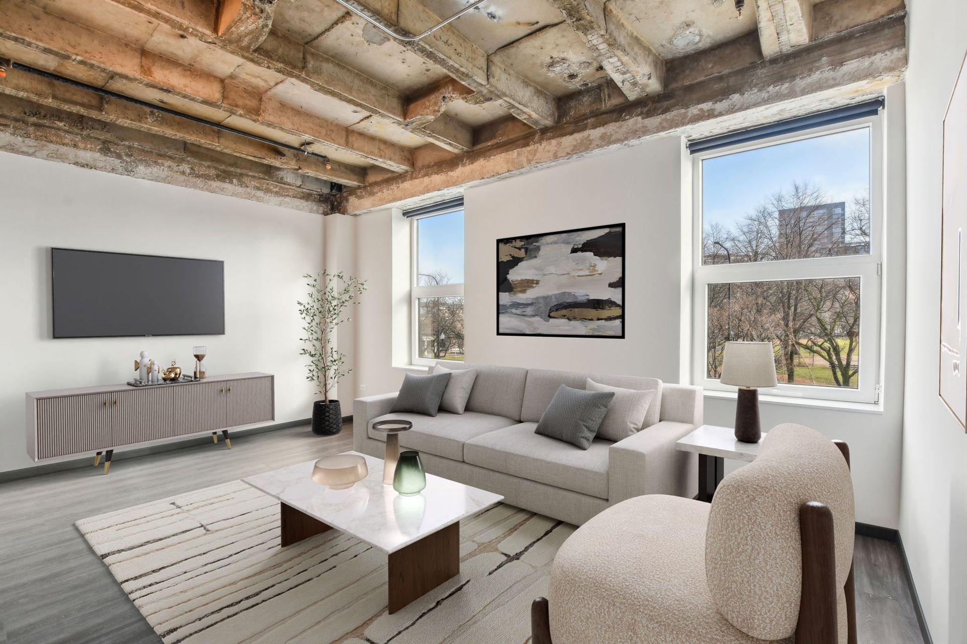 A living room with a couch , chairs , coffee table and television.
