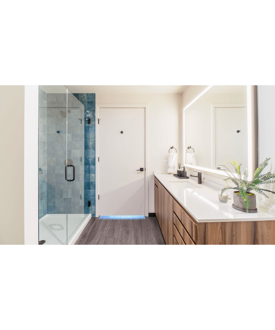 modern apartment bathroom with a walk-in shower surrounded by blue tile