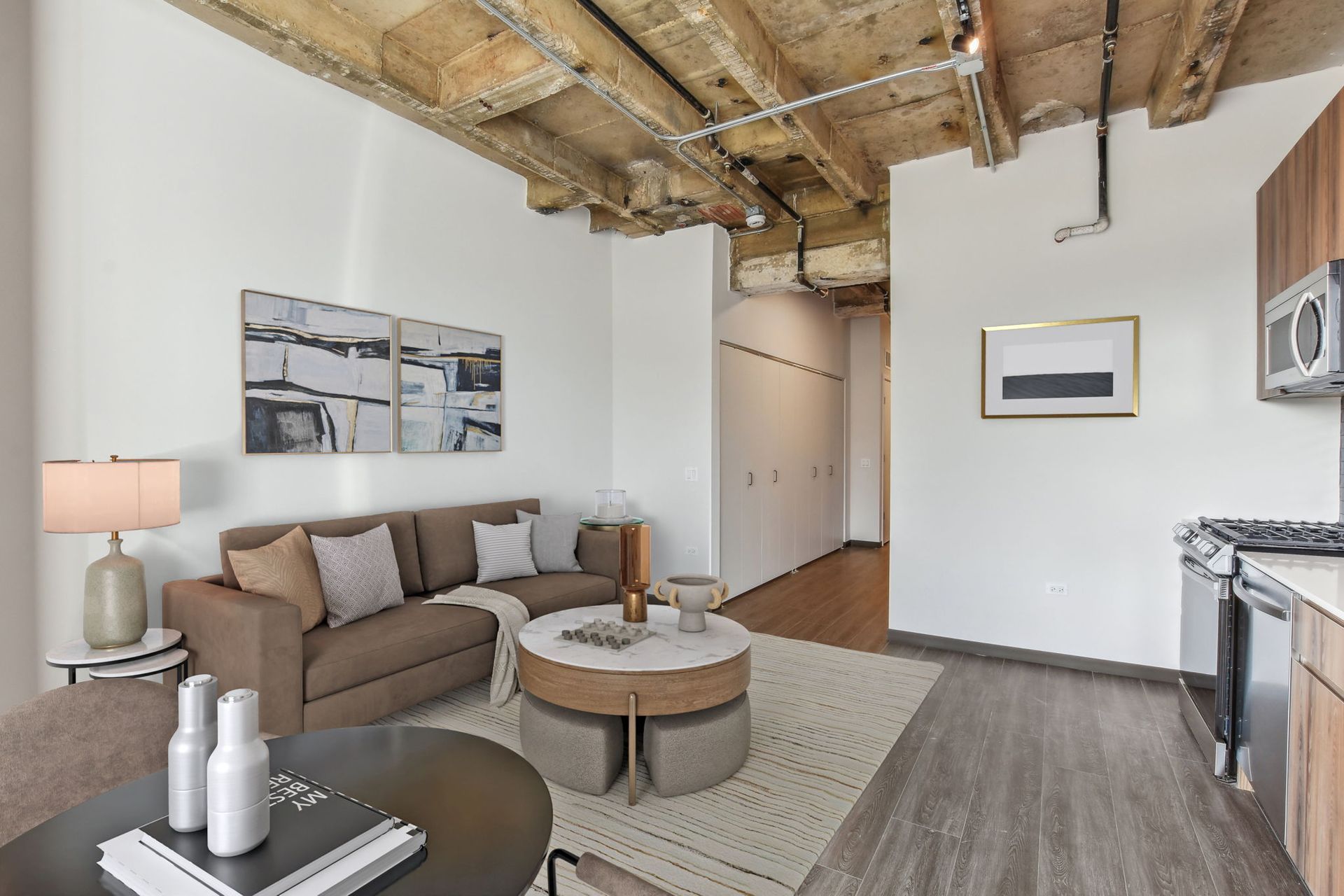 A living room with a couch , coffee table , and microwave.