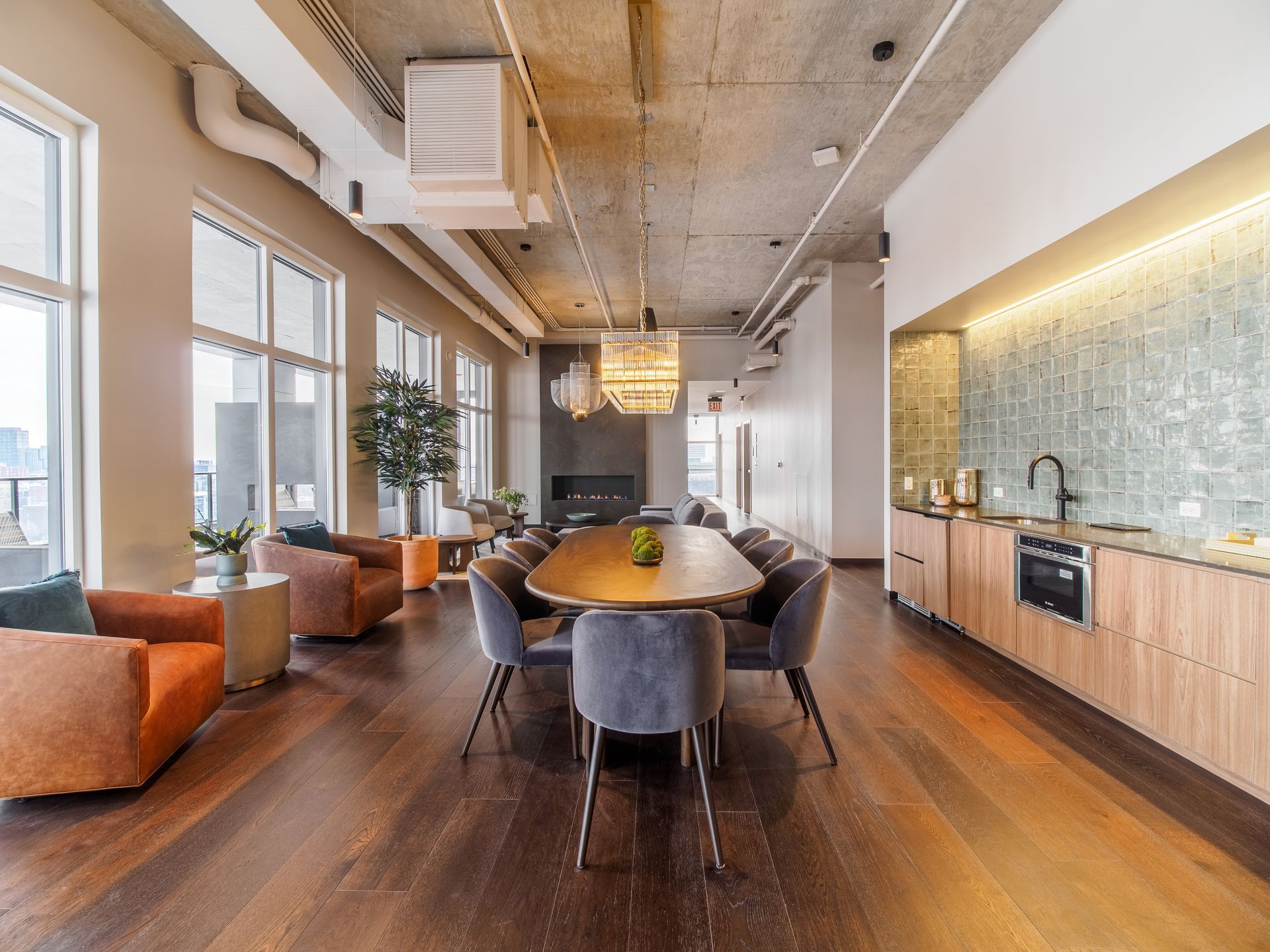 large dining table with velvet chairs in the The Thompson at Fulton Market apartment community lounge