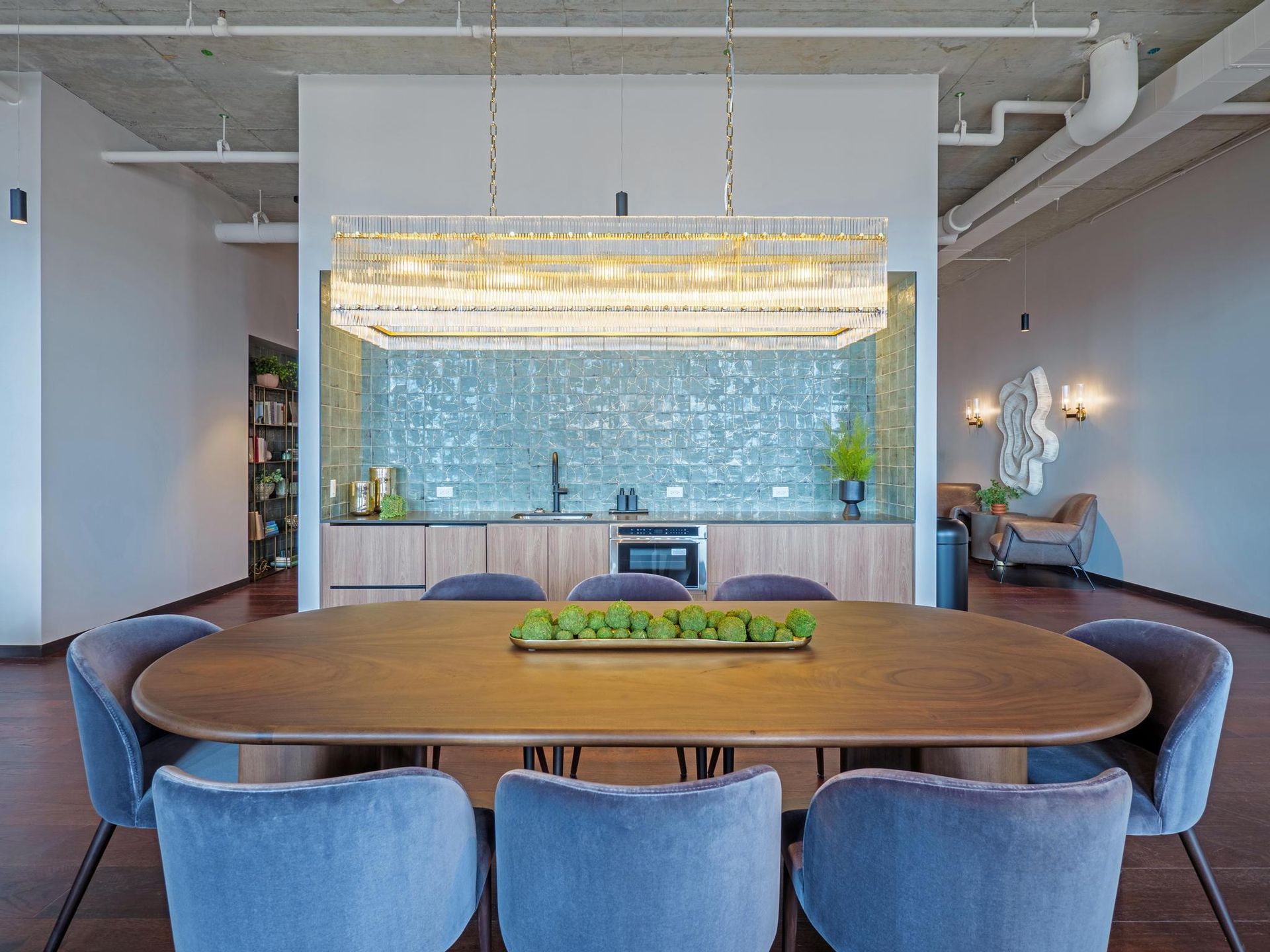 dining table with blue velvet chairs in front of a coffee bar at The Thompson at Fulton Market