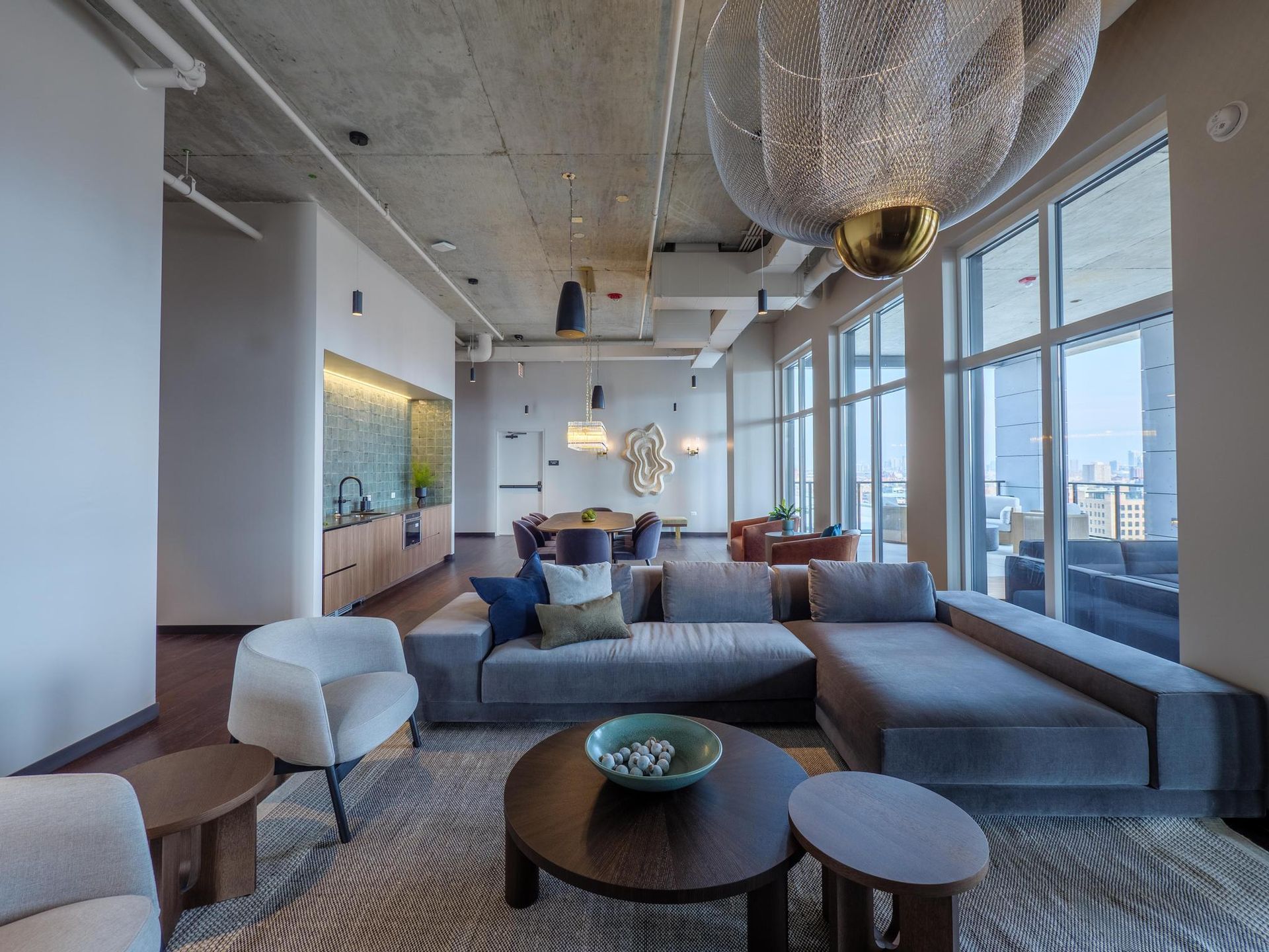 gray velvet sectional and round coffee tables in The Thompson at Fulton Market apartment community lounge
