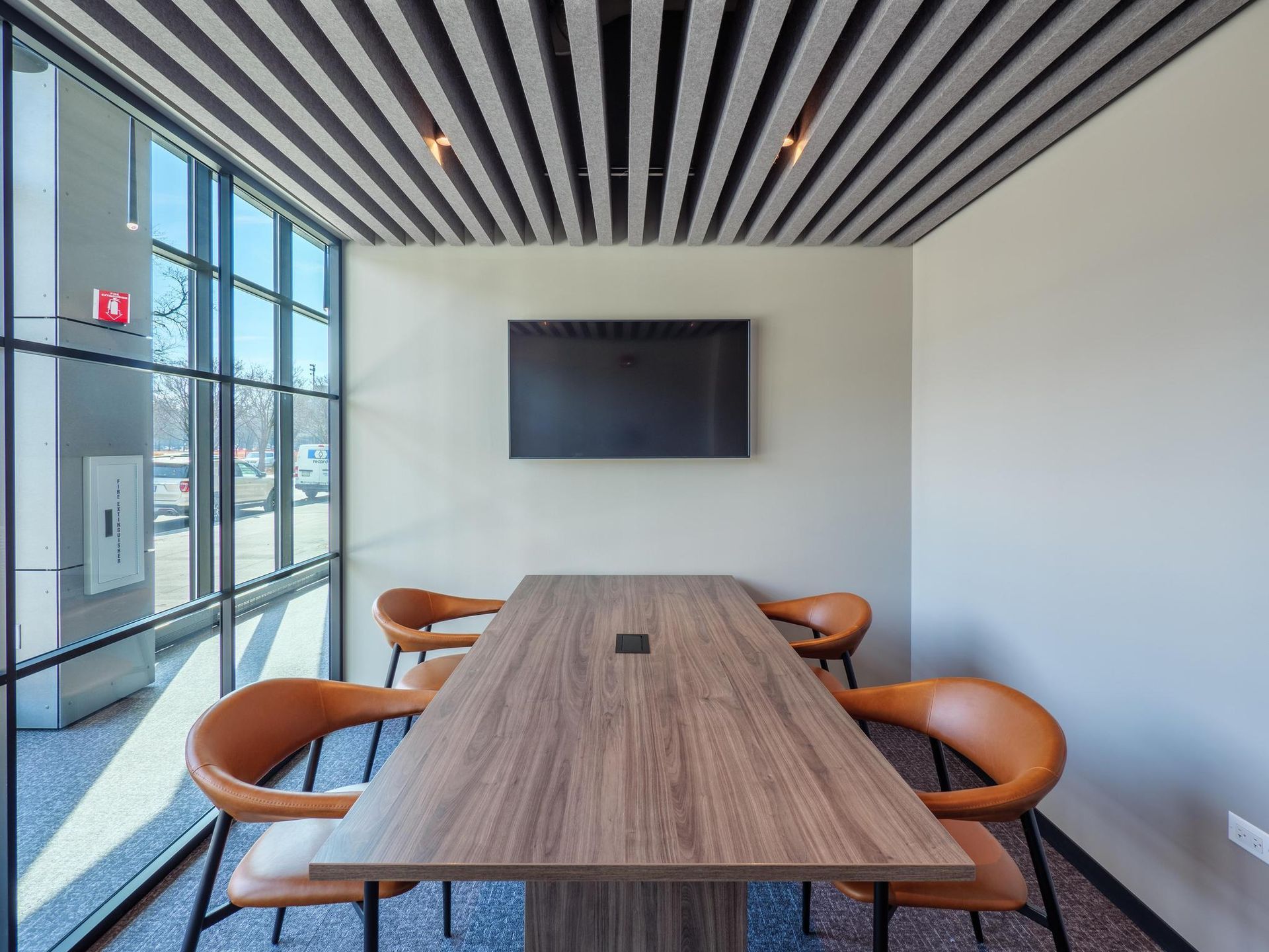 A conference room with a long wooden table and chairs