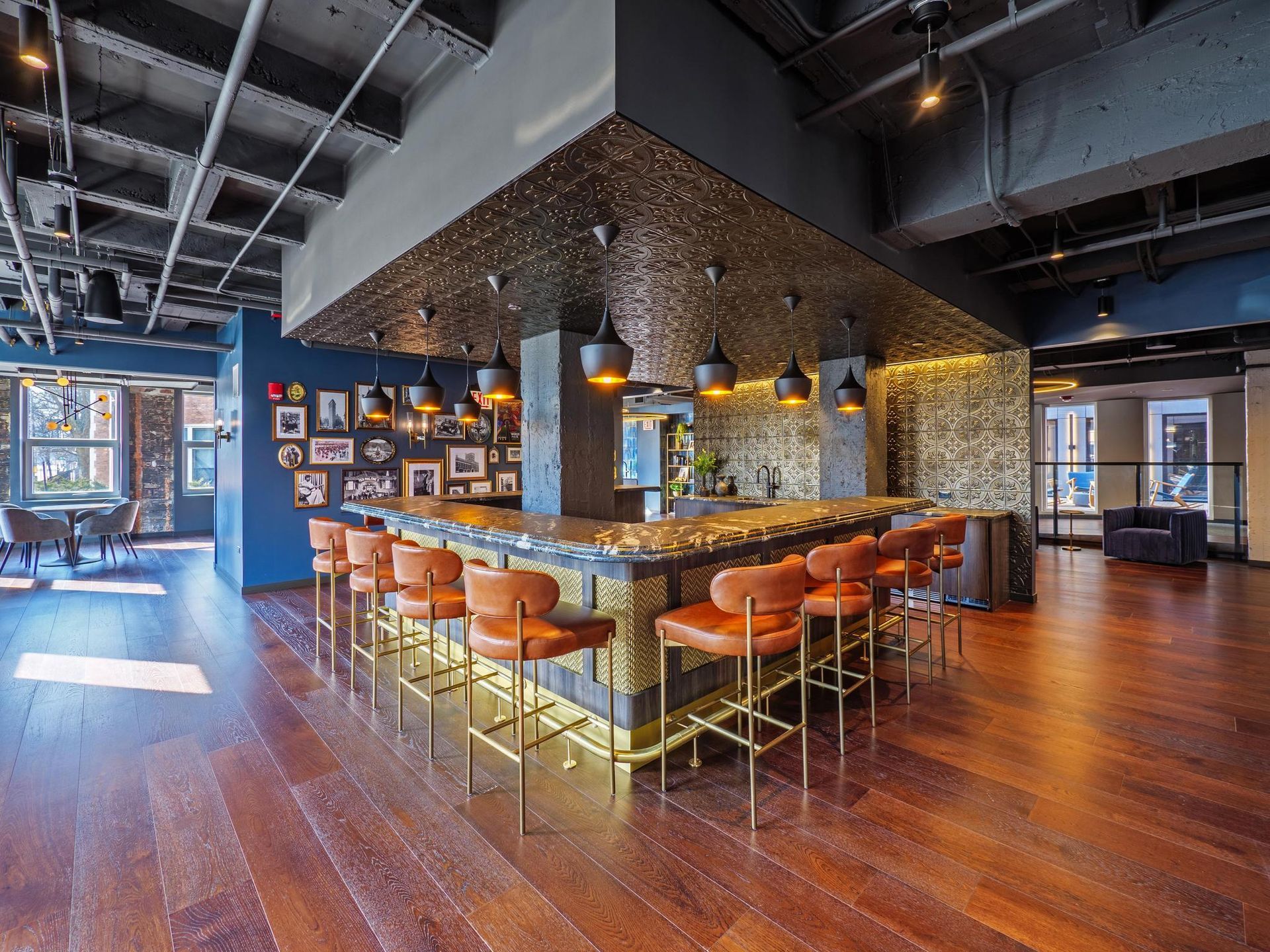 A large room with a bar and chairs in it