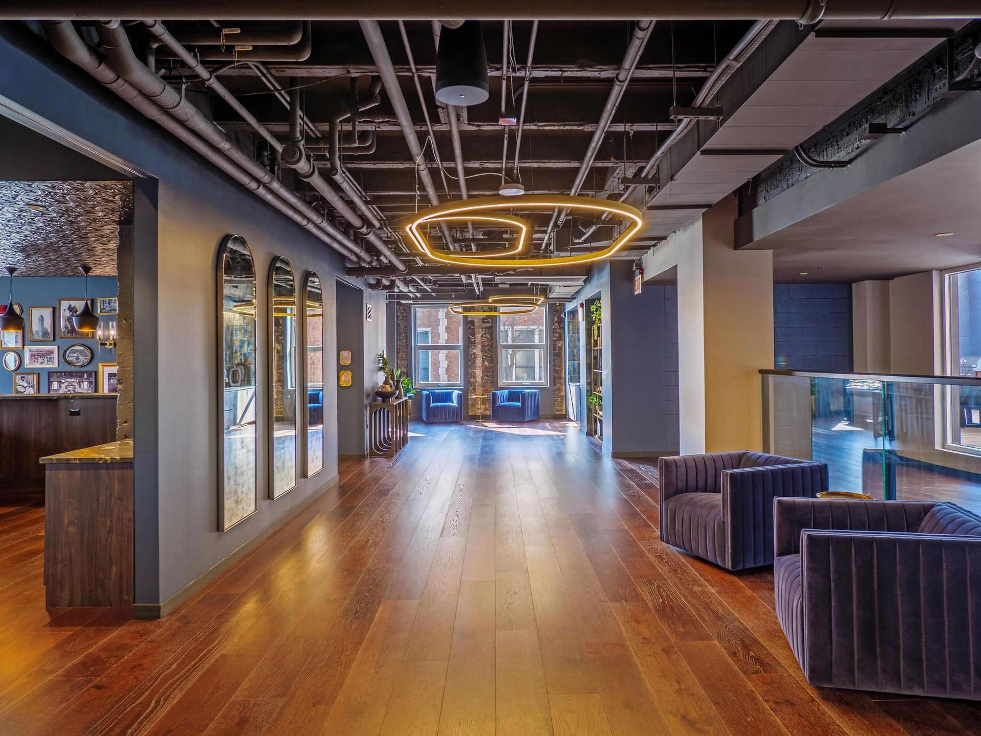 spacious hallway with wall mirrors in the resident lounge at The Thompson at Fulton Market Apartments