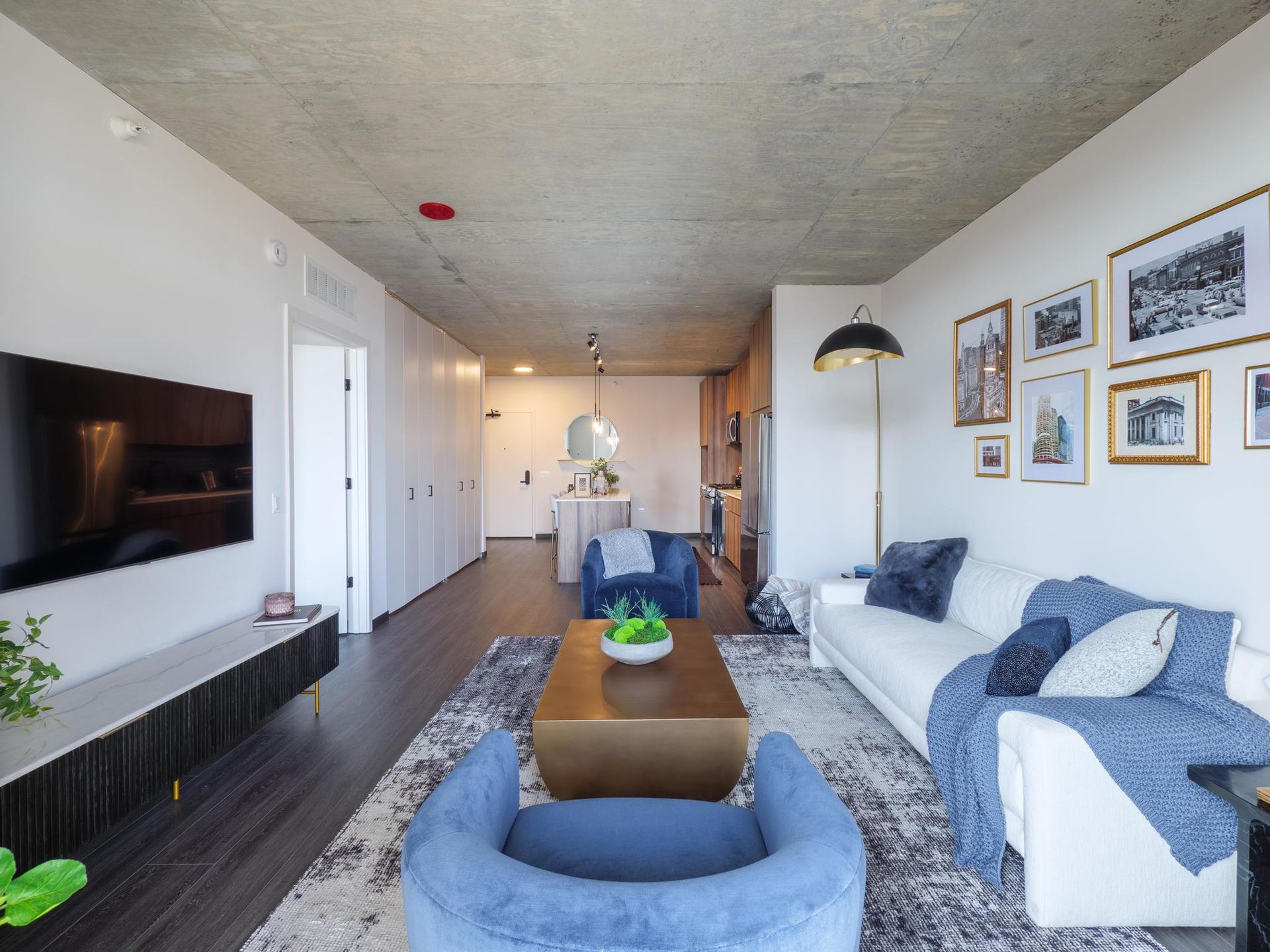 beautifully furnished living room opening to the kitchen of a Fulton Market apartment at The Thompson