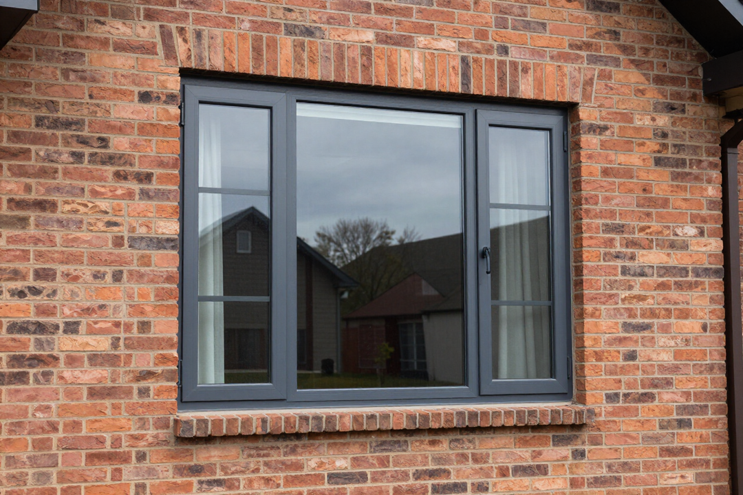 Freshly installed casement window on brick residential facade
