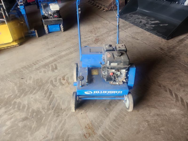 Blue wheeled floor machine with engine in a workshop garage on a concrete floor