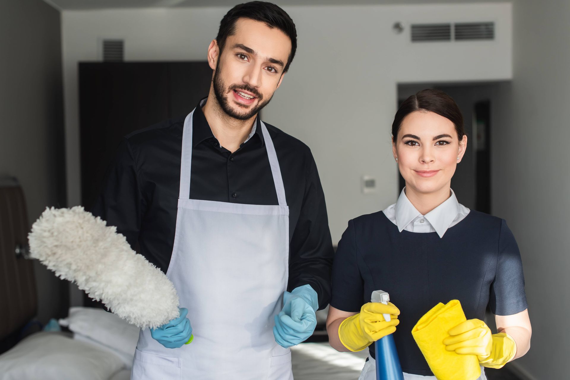 Happy housekeepers looking at camera for EDM Home Services