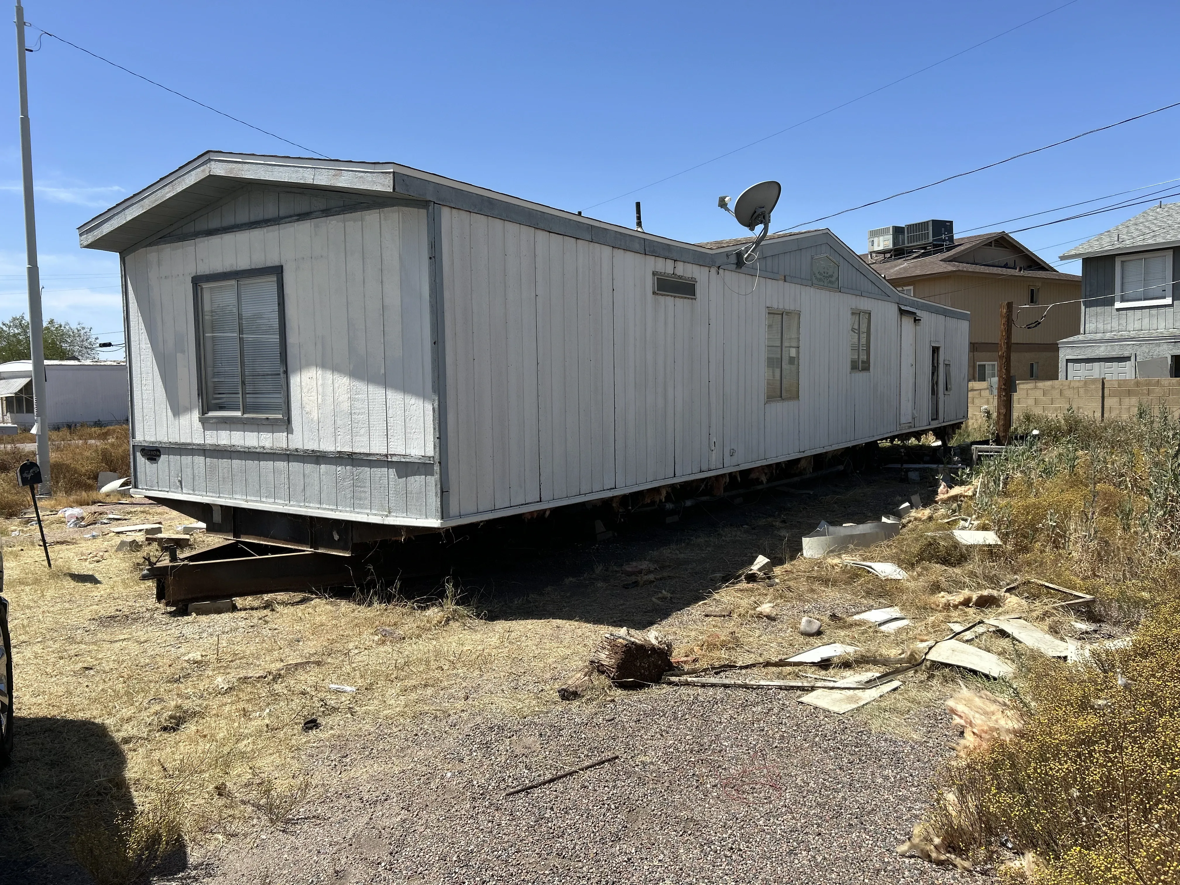 Older manufactured home with no skirting and exposed underside
