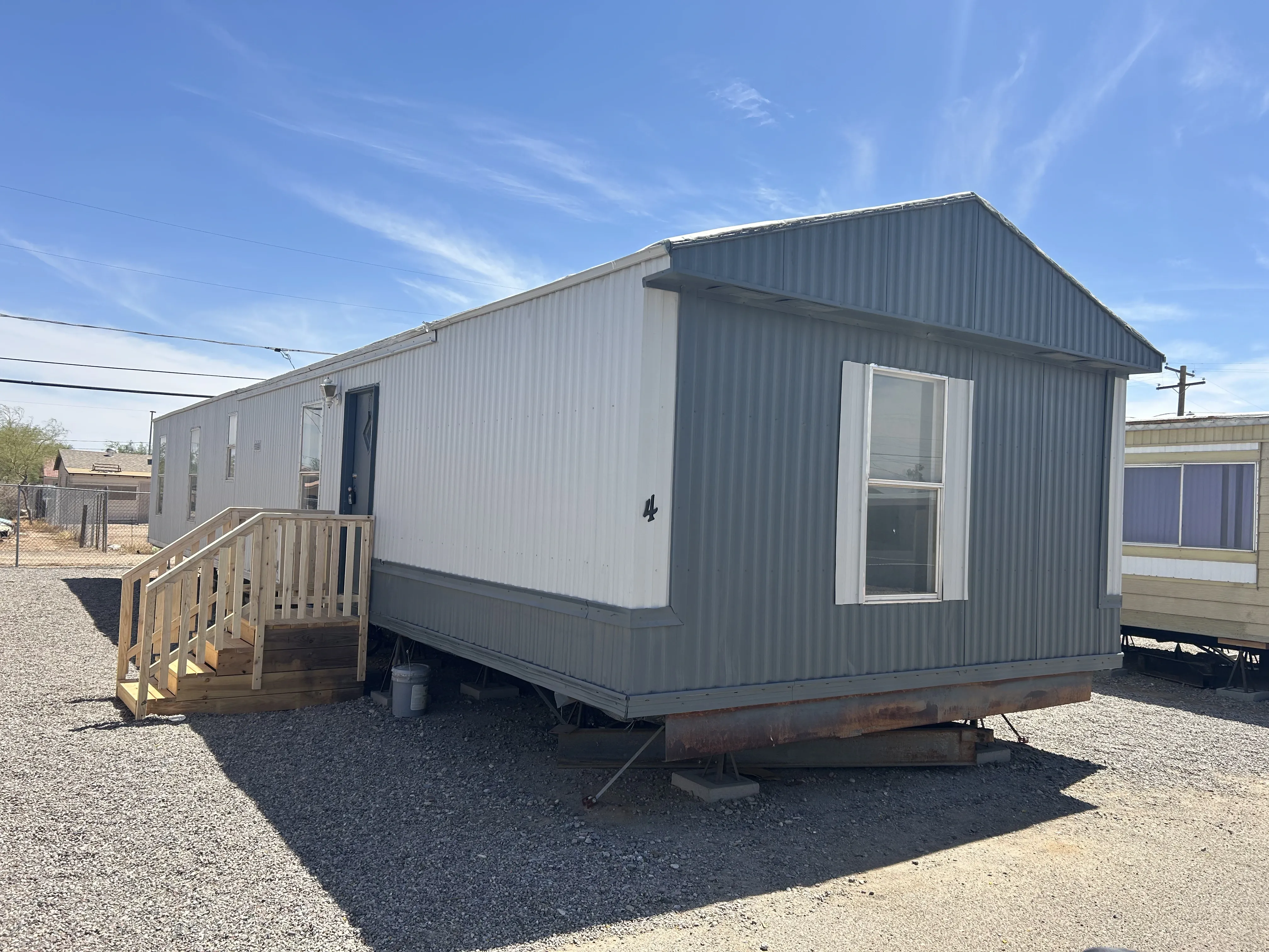Manufactured home set on piers with new wood stairs