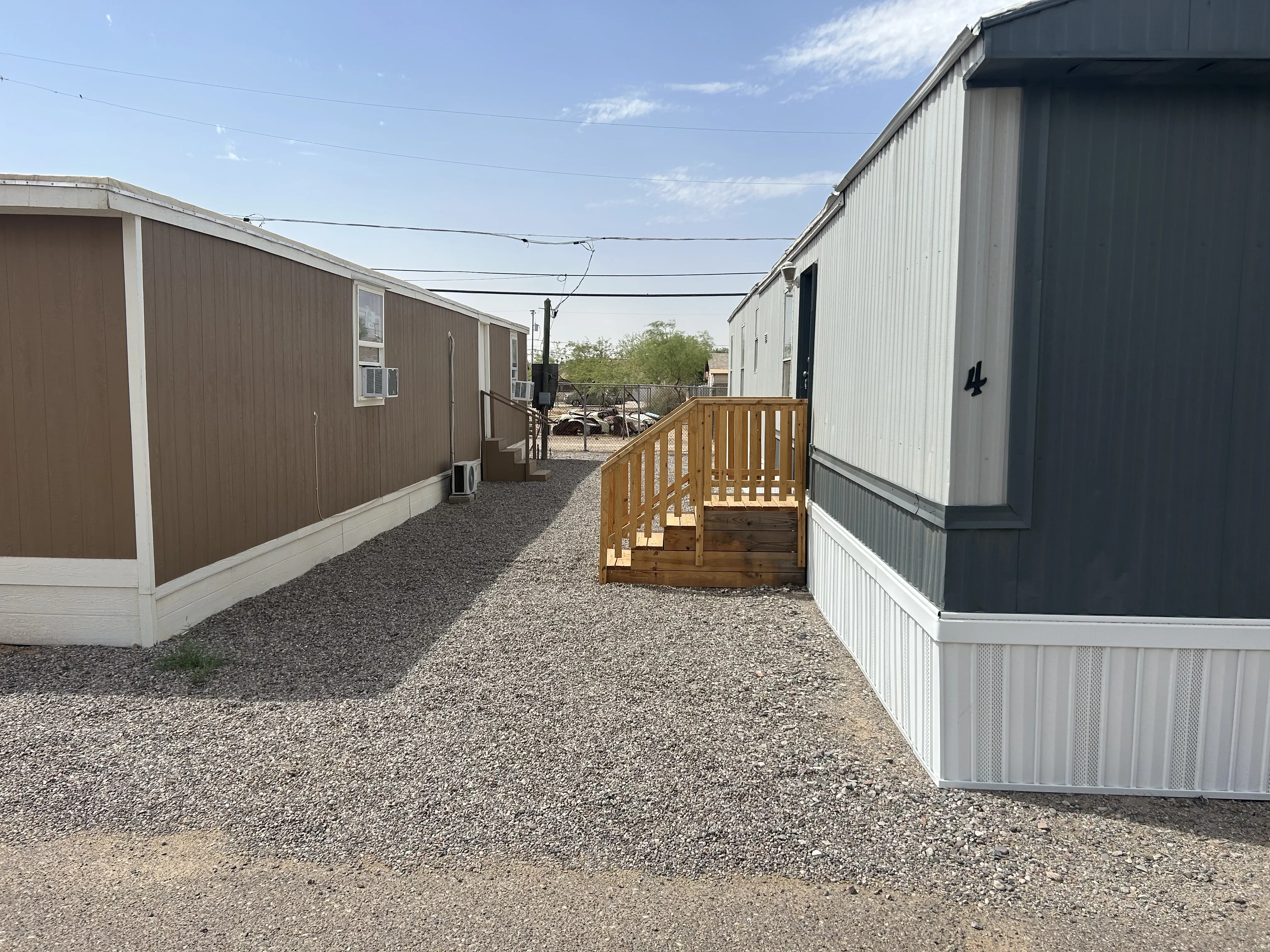 Two manufactured homes with clean gravel and new wood stairs