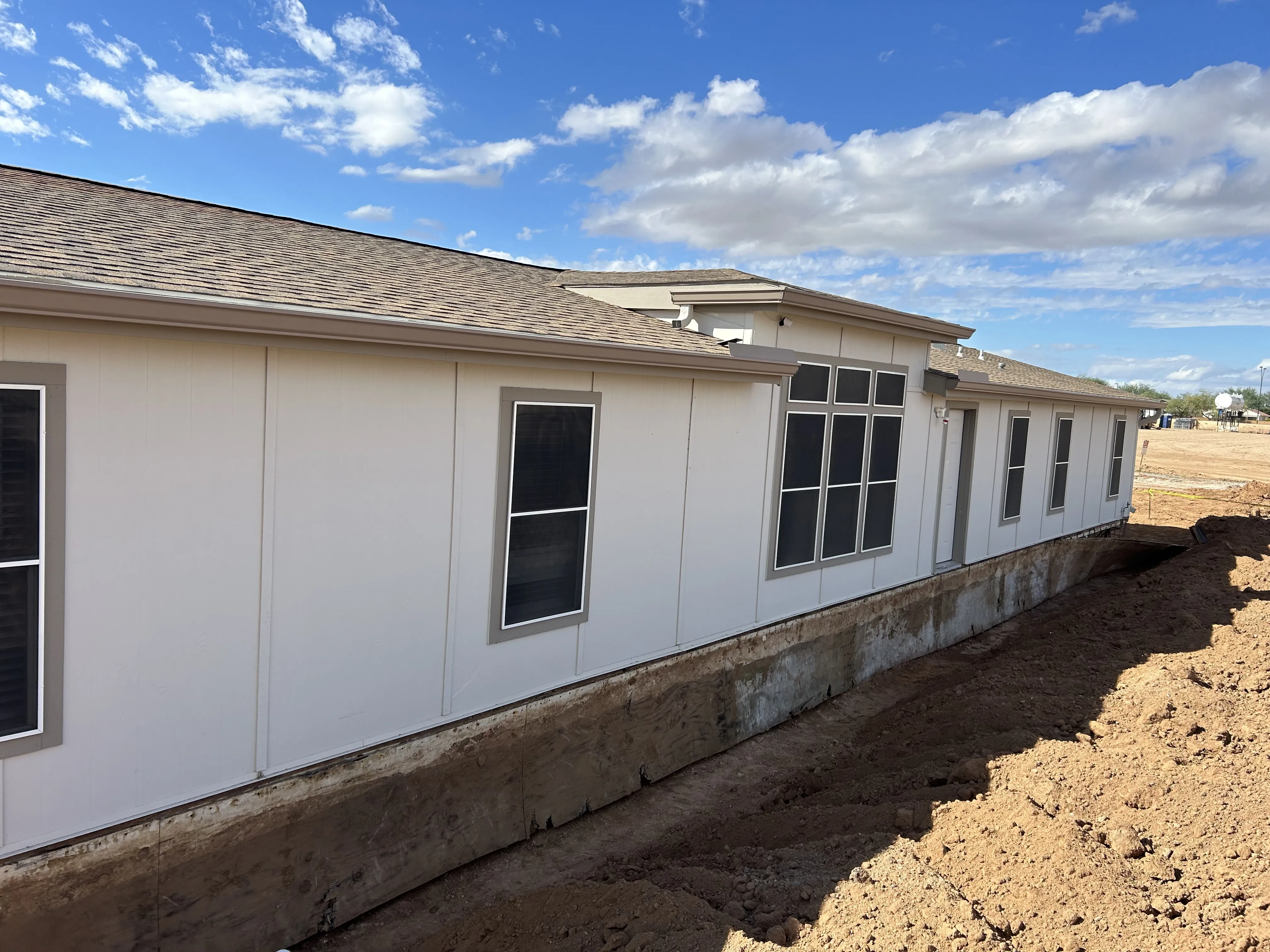 Side wall of a manufactured home on a new foundation
