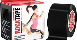 Roll of black RockTape beside box showing a woman stretching with the brand name RockTape