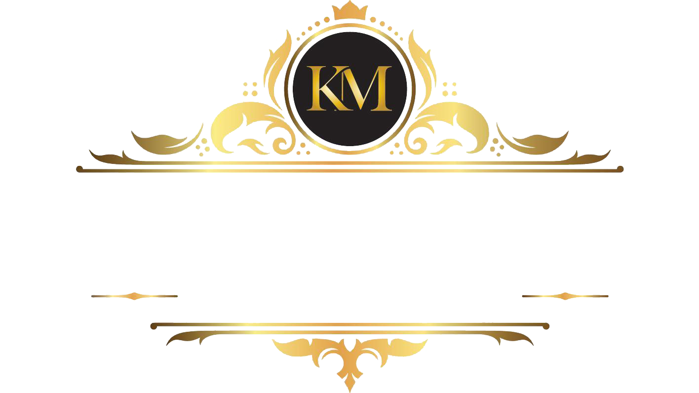 Gold ornamental logo with black circle monogram “KM” centered between decorative flourishes.