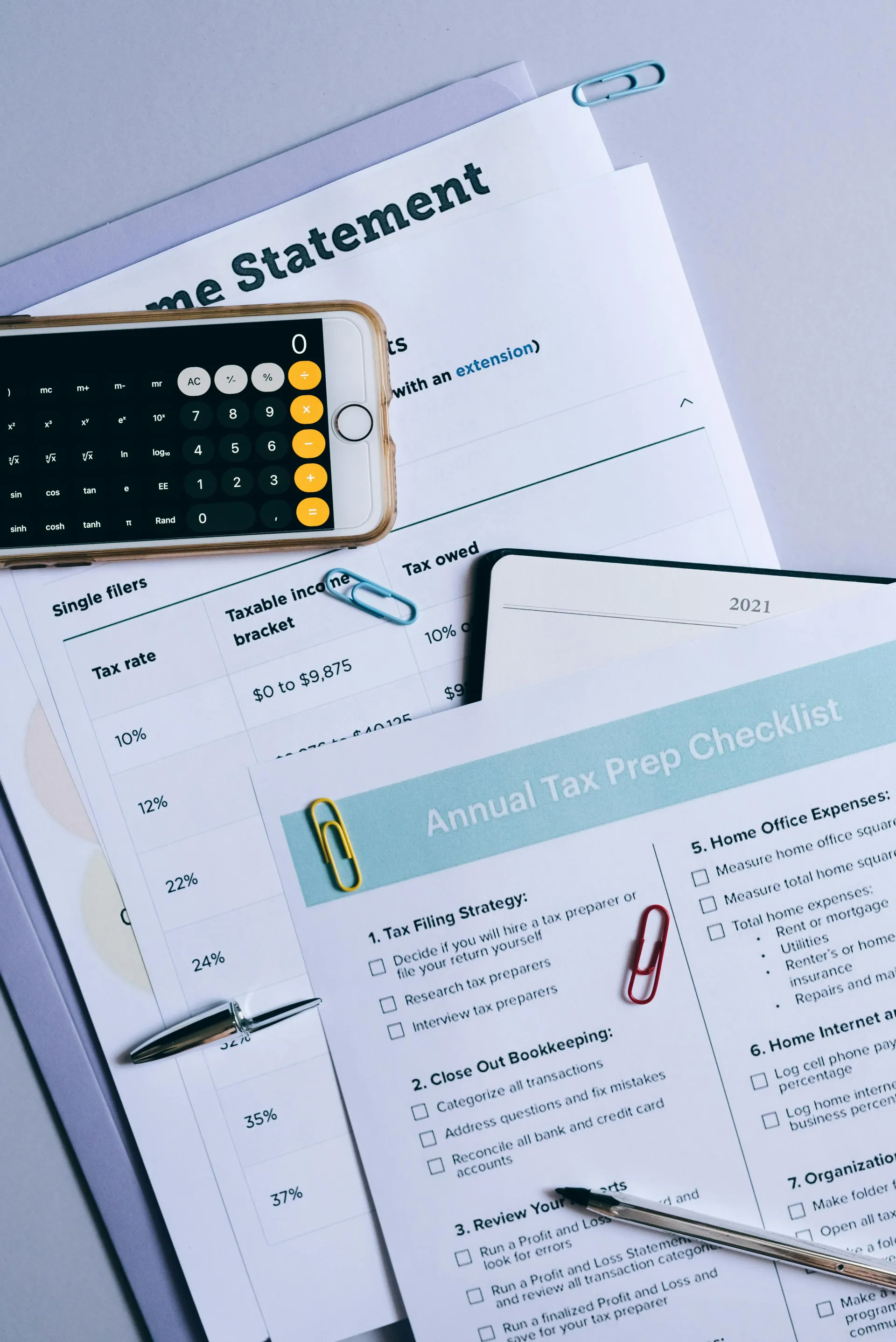 Budget and account statements with calculator, pen, and papers on a desk