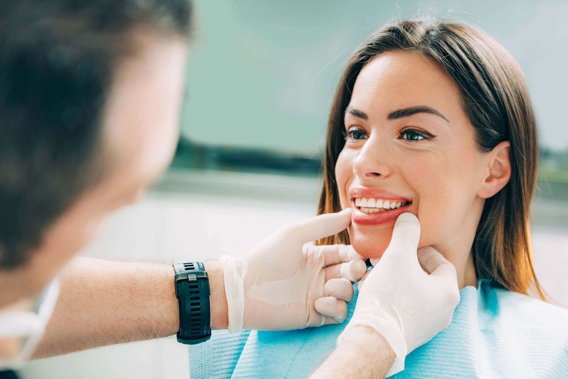 A dentist is looking at a patient’s teeth. A dentist is looking at a patient’s teeth.