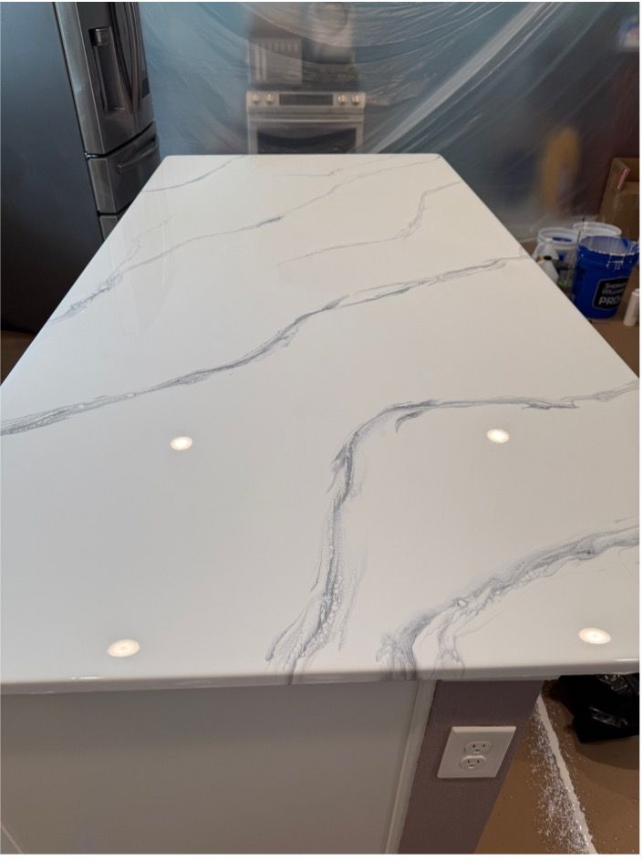 White quartz countertop with gray veining on a kitchen island.