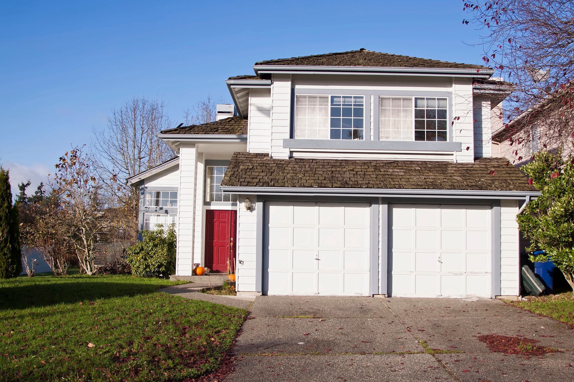 Two-story suburban house with red front door and double garage