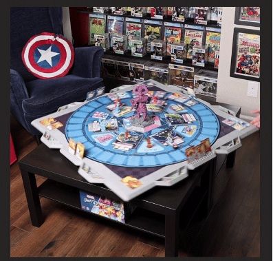 A table with a board game on it and a captain america pillow