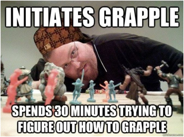 A man with glasses and a hat leans over a tabletop game with figures, grinning, text: 