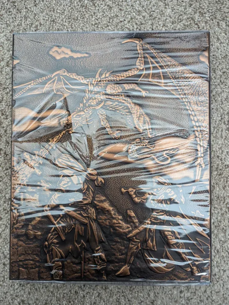 A painting of a dragon is wrapped in plastic and sitting on a carpet.