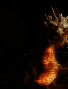 Burning dragon's horn in a dark setting.