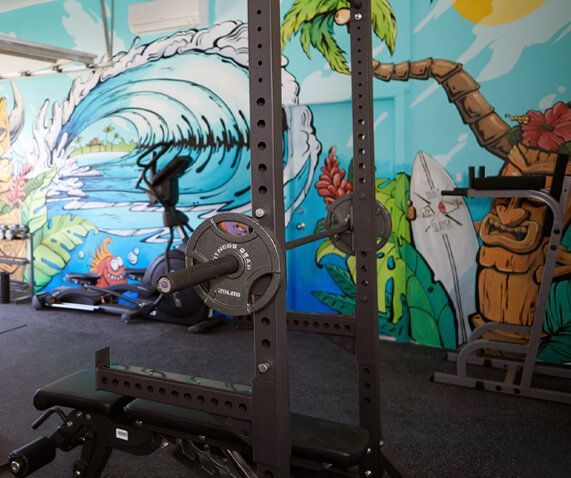 A gym with a mural of a wave on the wall