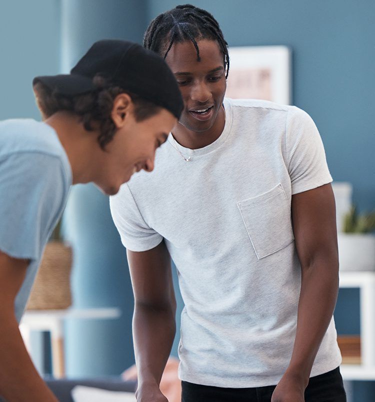 Two men are standing next to each other looking at something