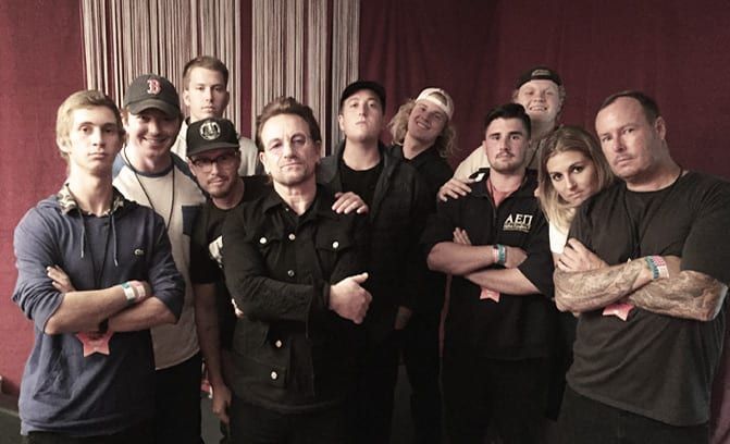 A group of people standing next to each other with their arms crossed.