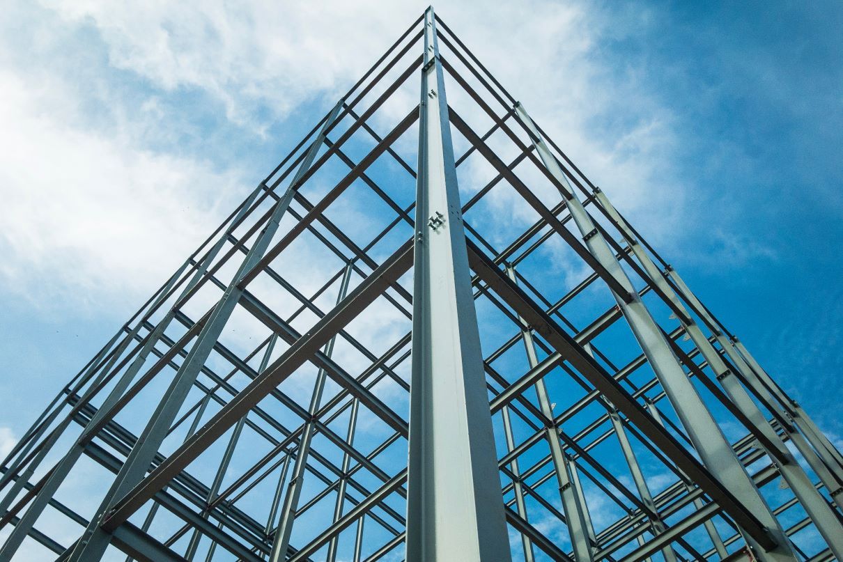 Looking up at a building under construction with a blue sky in the background