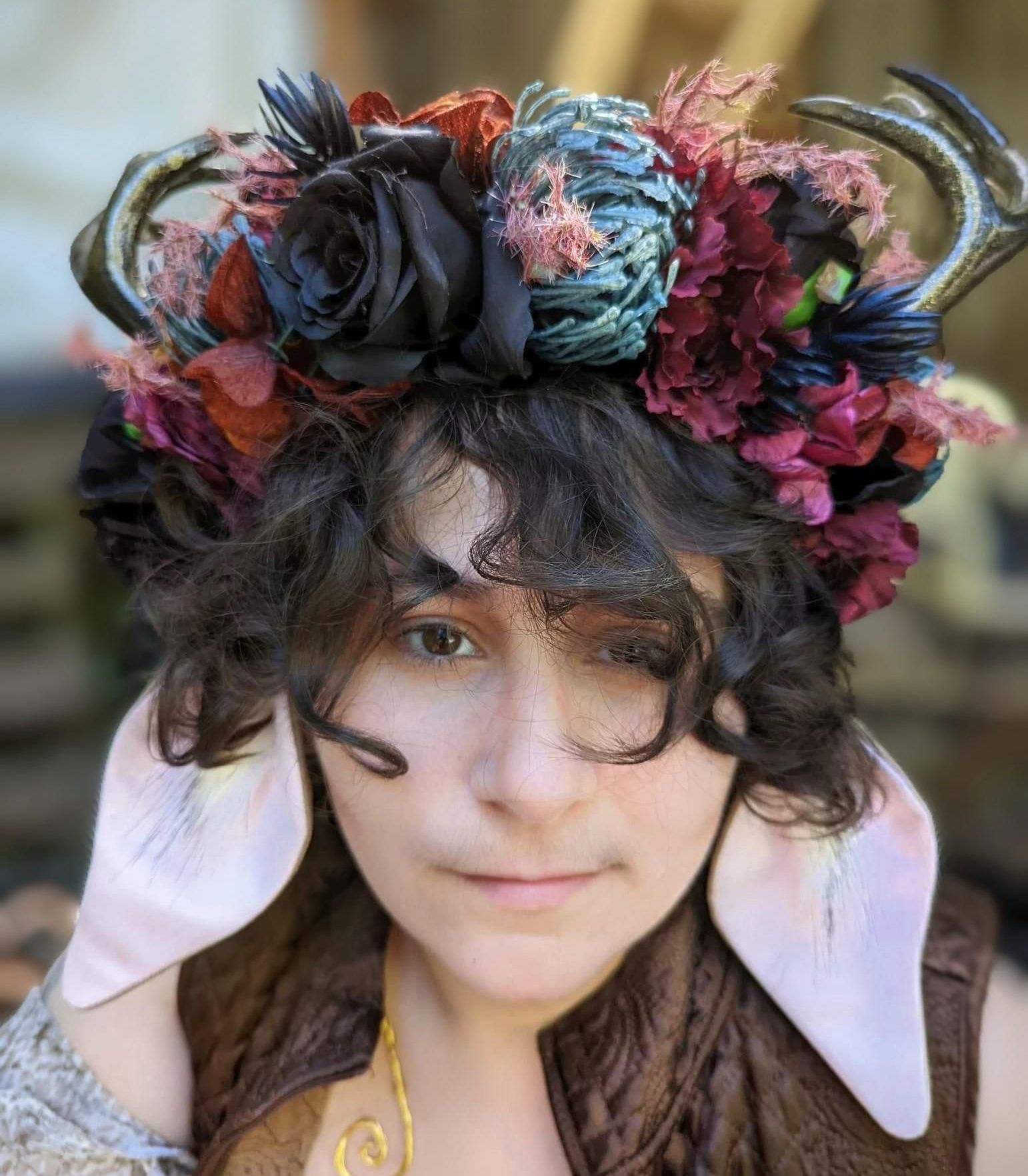 A woman is wearing a crown of flowers and ears, Selena Bentley.