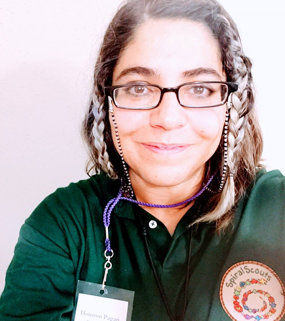 A woman wearing glasses and a green shirt, Aedis LaVeau.