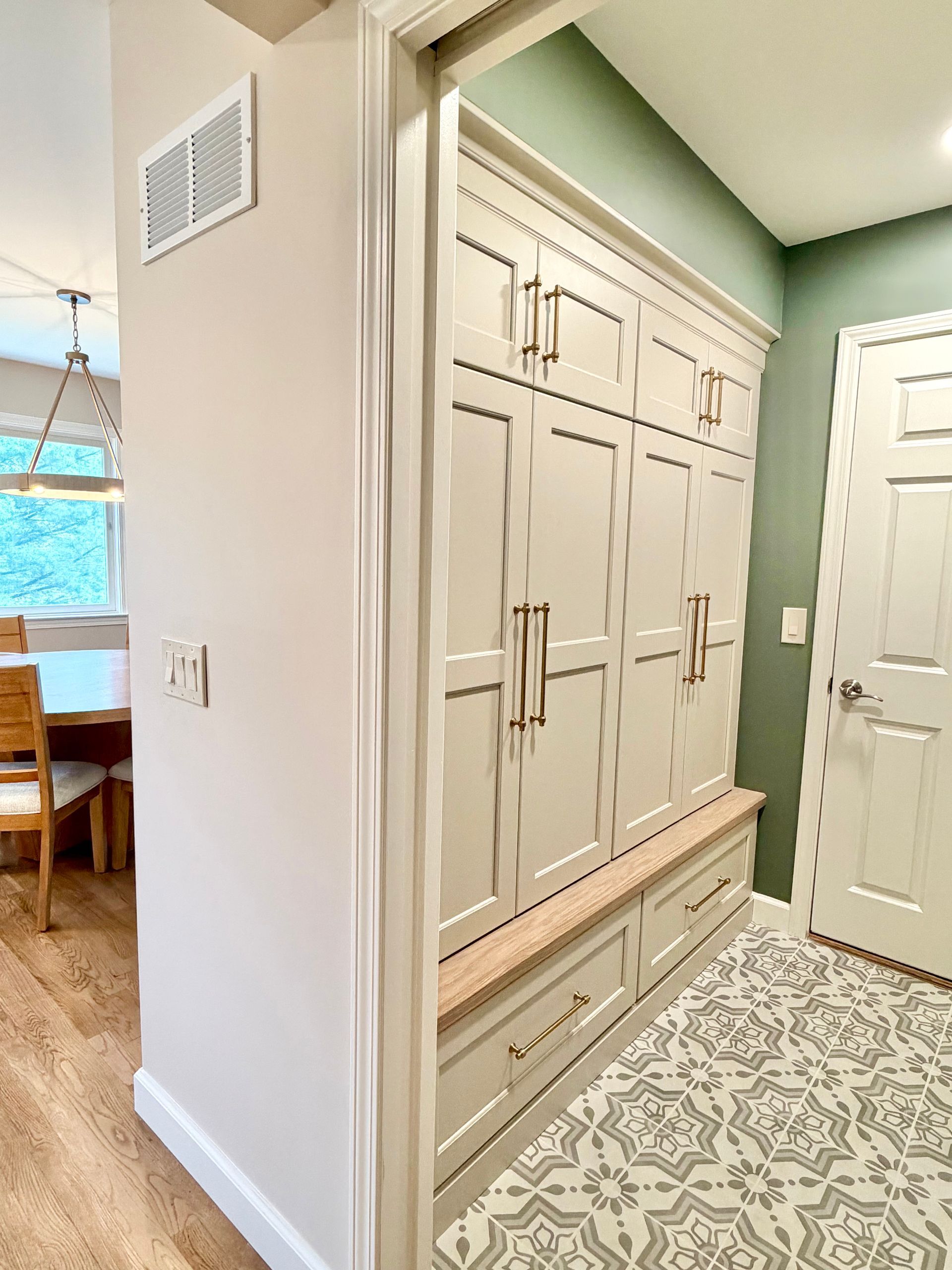 Craftsperson fitting a custom built-in cabinet panel during installation in a Northern Kentucky home