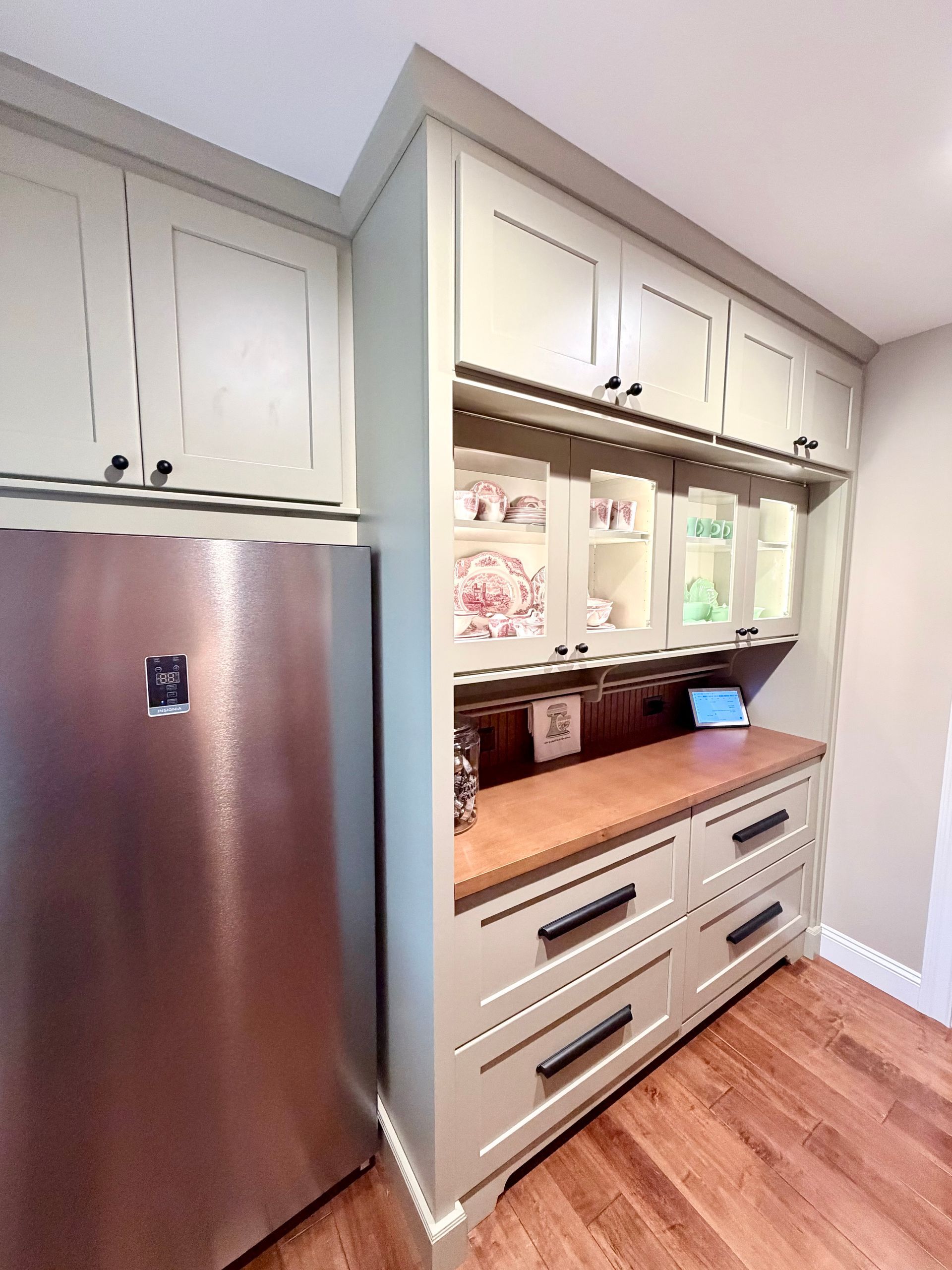 Design consultant reviewing cabinetry in a Northern Kentucky kitchen