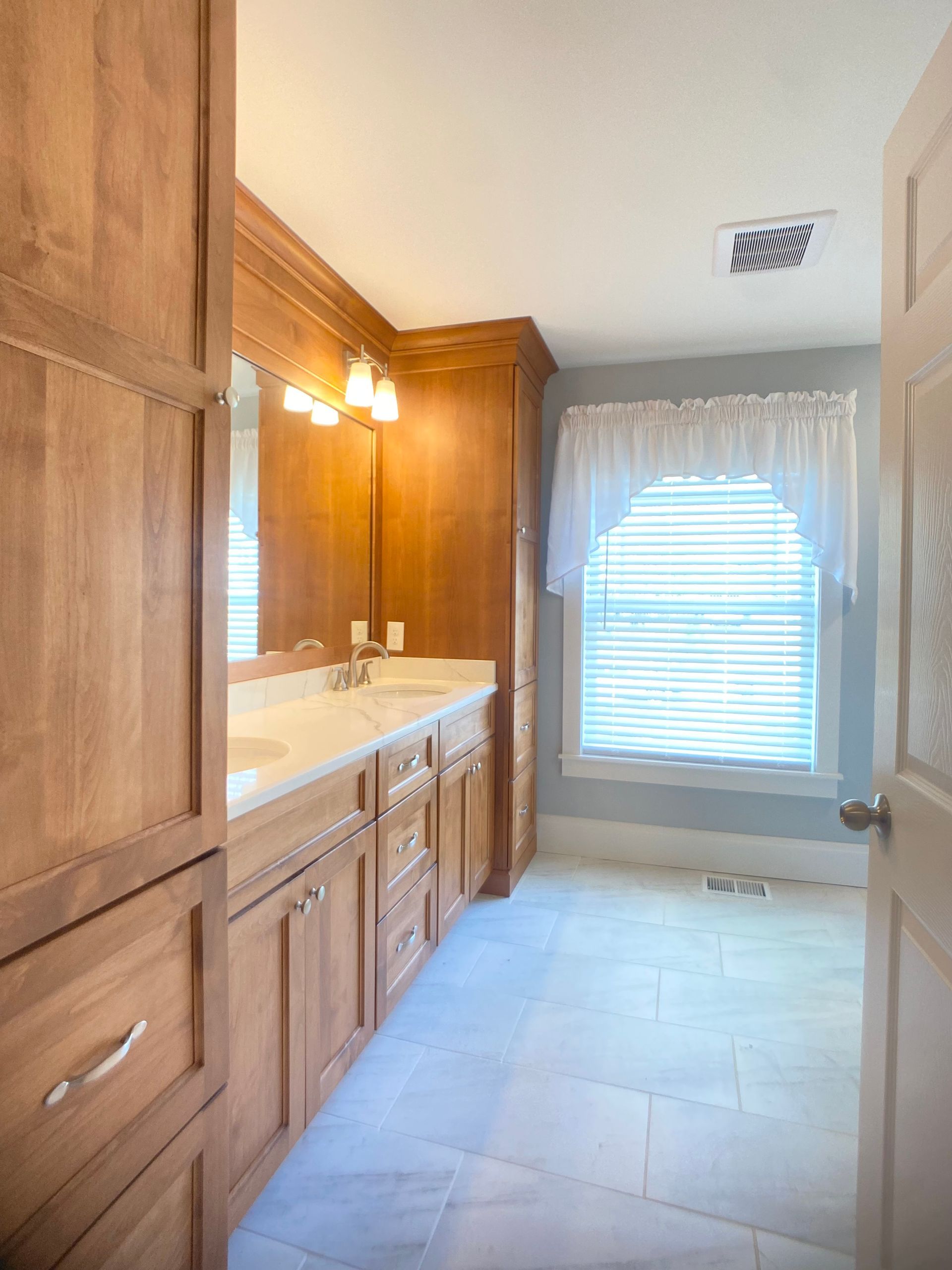 Custom bathroom vanity cabinetry with stone countertop installed by Wood and Stone Cabinet Design Studio in Northern Kentucky
