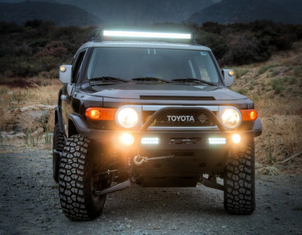 A Toyota Fj Cruiser With a Light Bar on Top of It is Parked on a Dirt Road  — Autofit88 Auto Electrics In Ciccone, NT